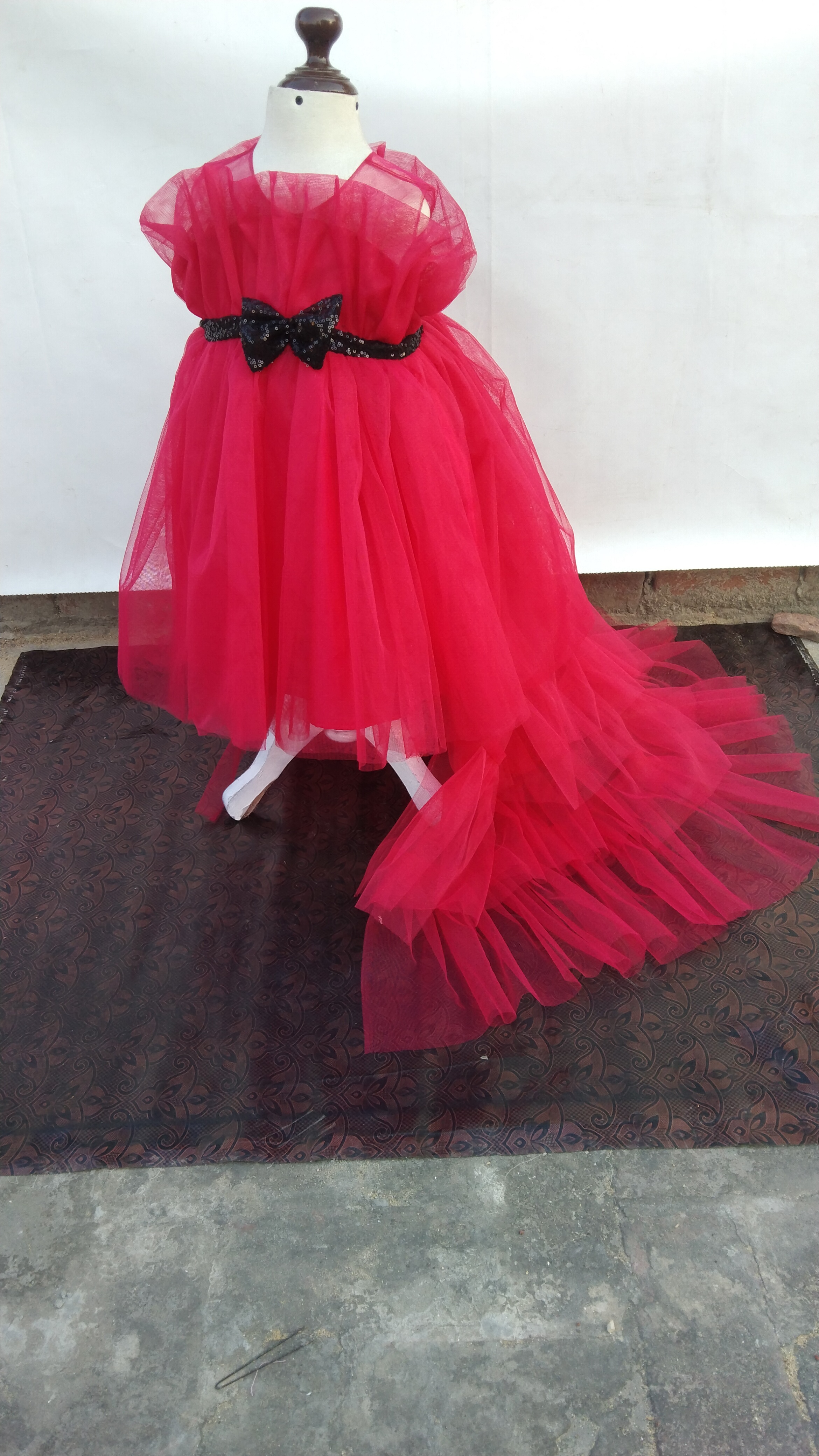 Candy Floss Cascade, The "Candy Floss Cascade" baby girls dress is a Barbie pink dream. Swirling tulle, ruffles, a sequin belt, and bows create a whimsical, voluminous design perfect for twirling.