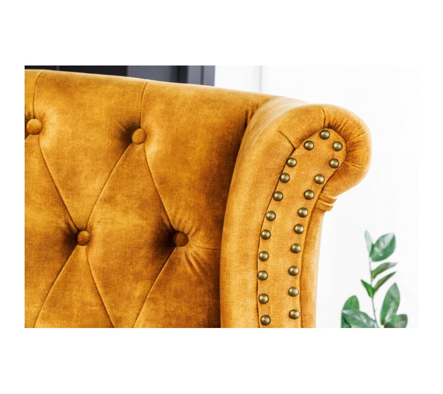 Chesterfield armchair Cella with velvet upholstery in mustard yellow with dark brown solid legs 105cm