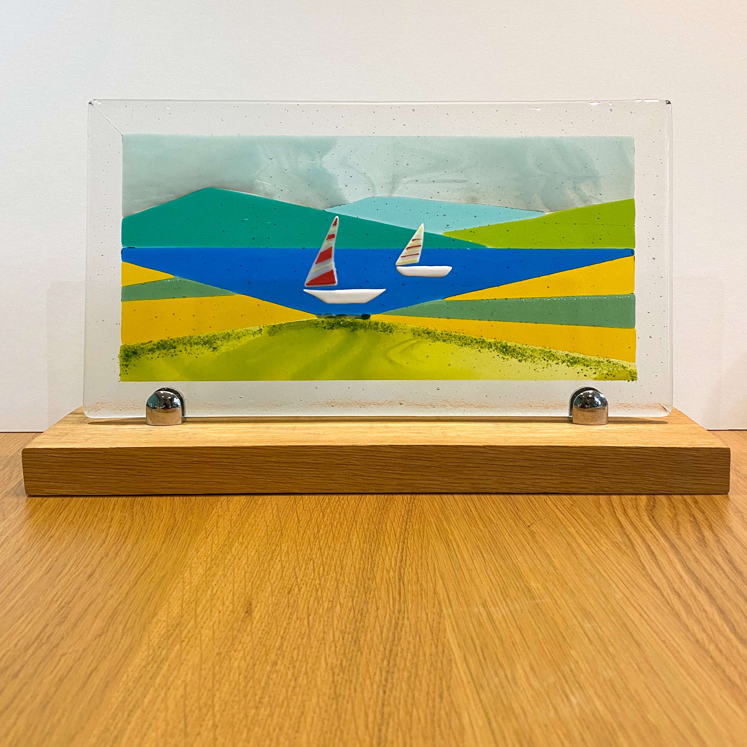 White boats on a lake with mountains