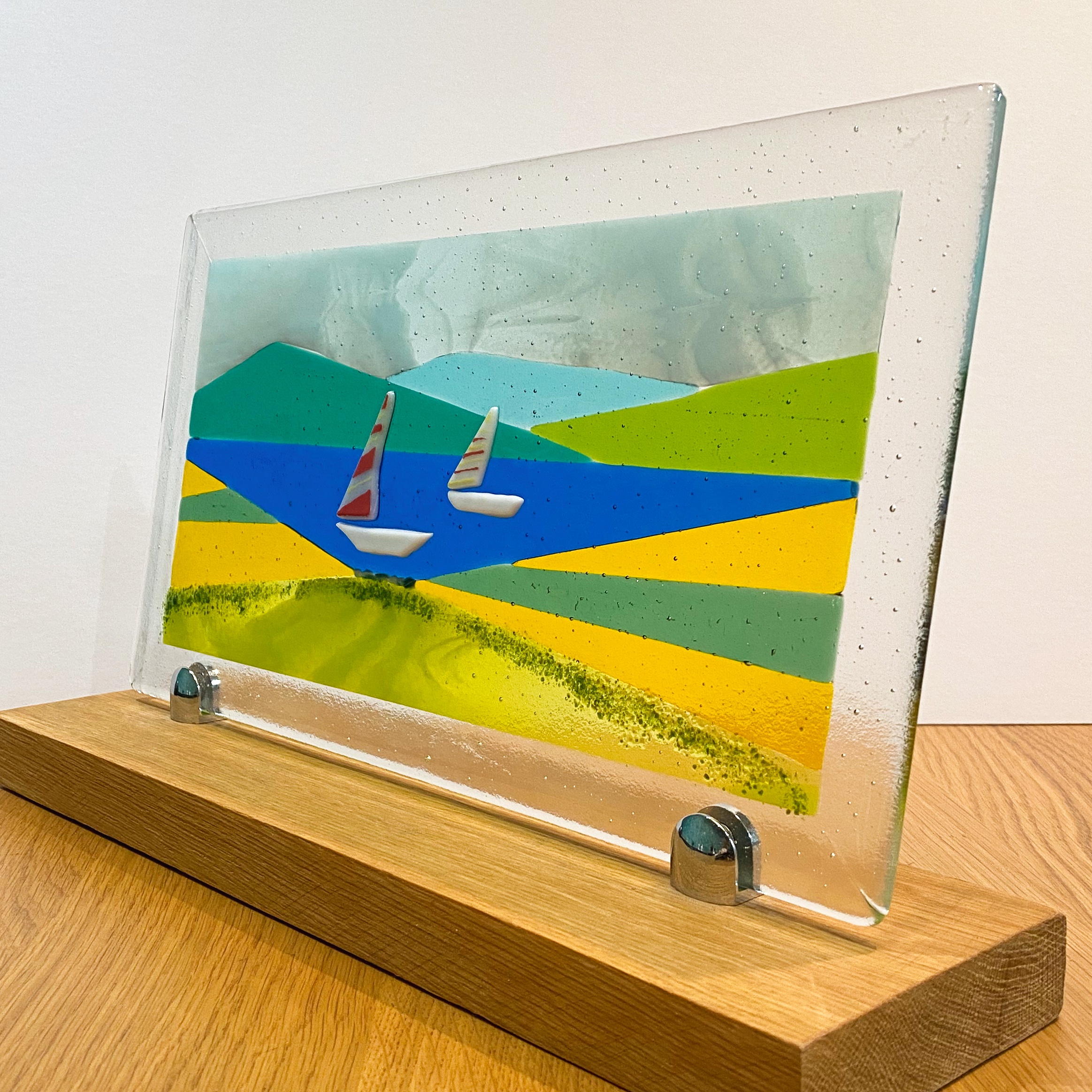 White boats on a lake with mountains