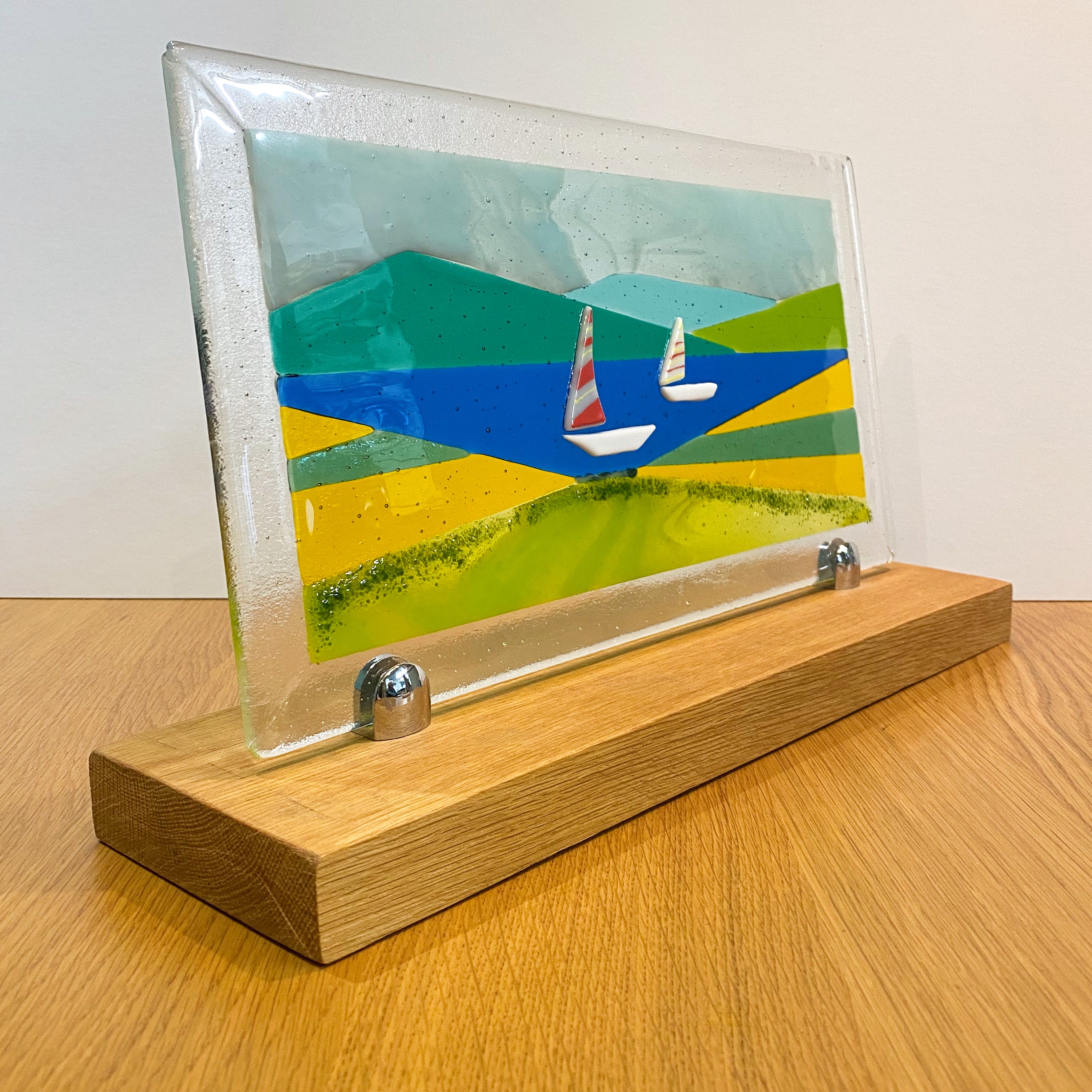 White boats on a lake with mountains