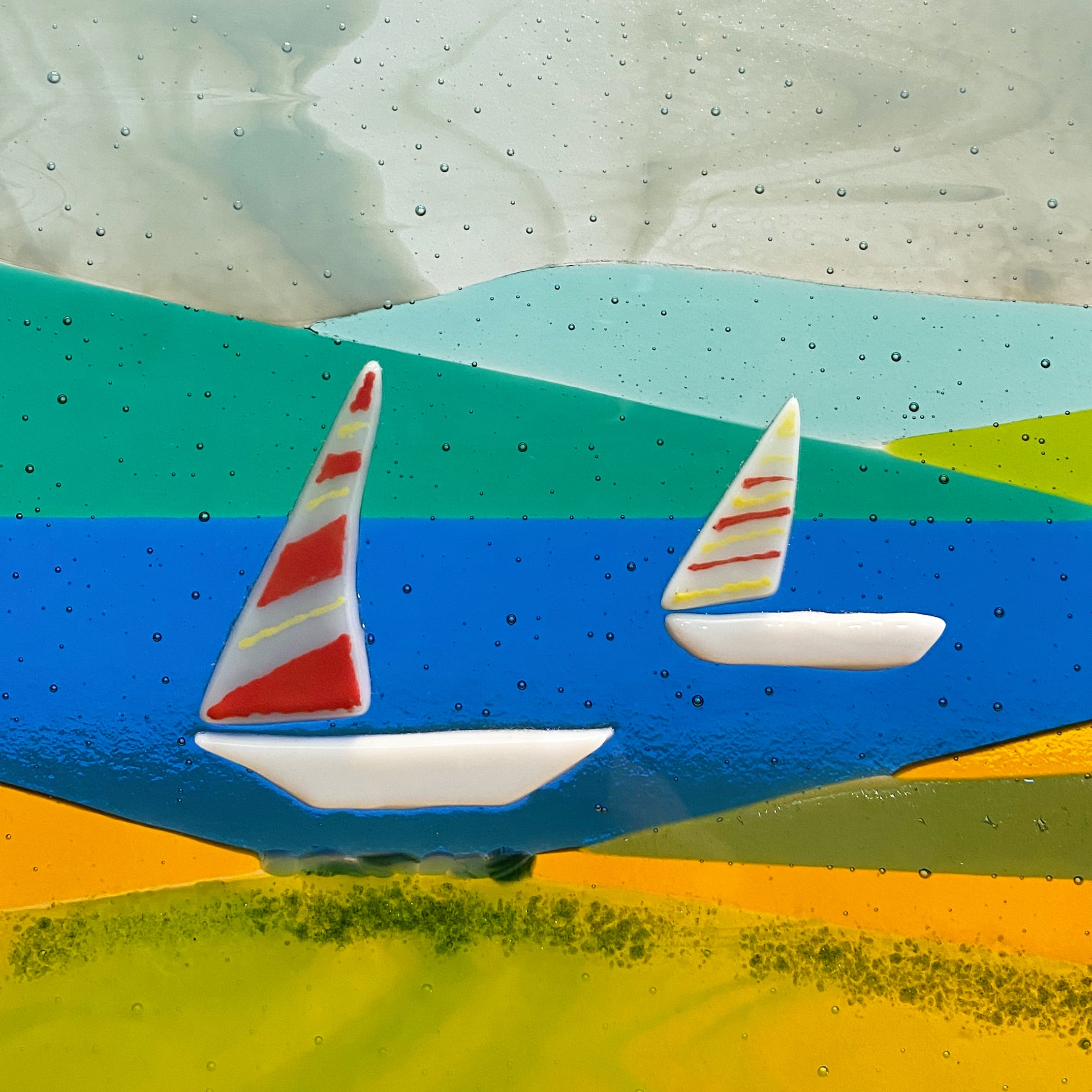 White boats on a lake with mountains