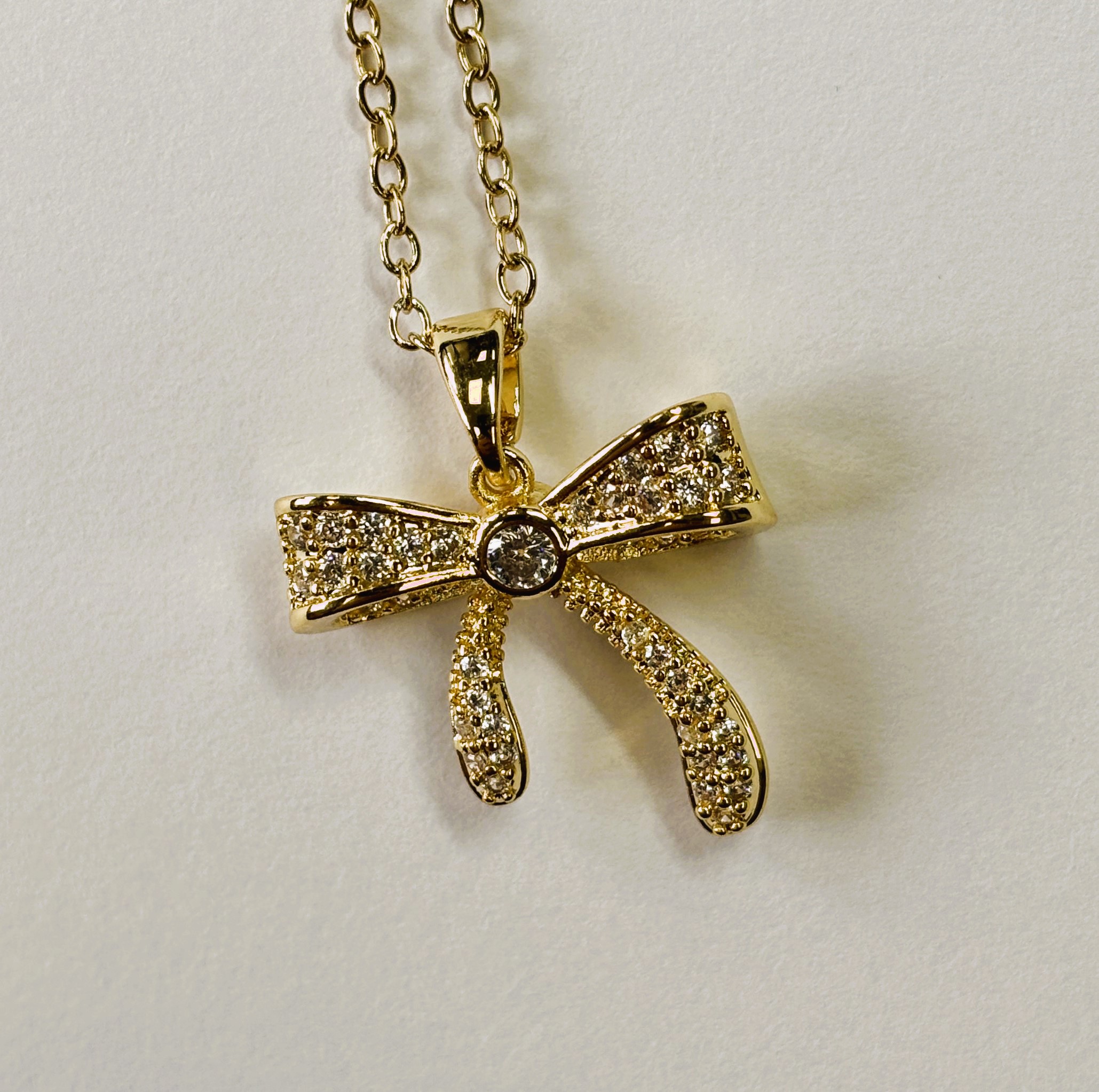 Gold Relief Zircon Sand Gift Bow Pendant Necklace