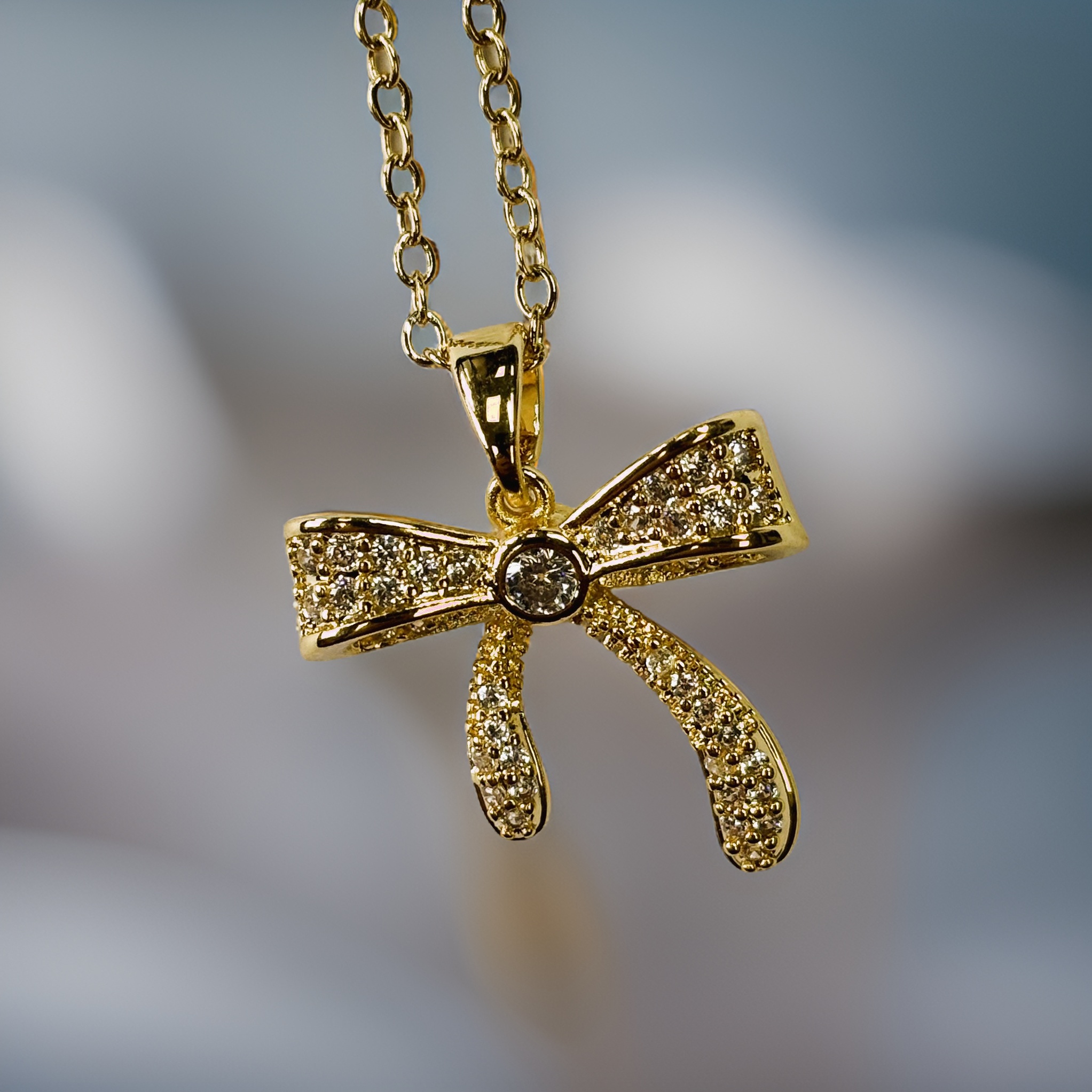 Gold Relief Zircon Sand Gift Bow Pendant Necklace