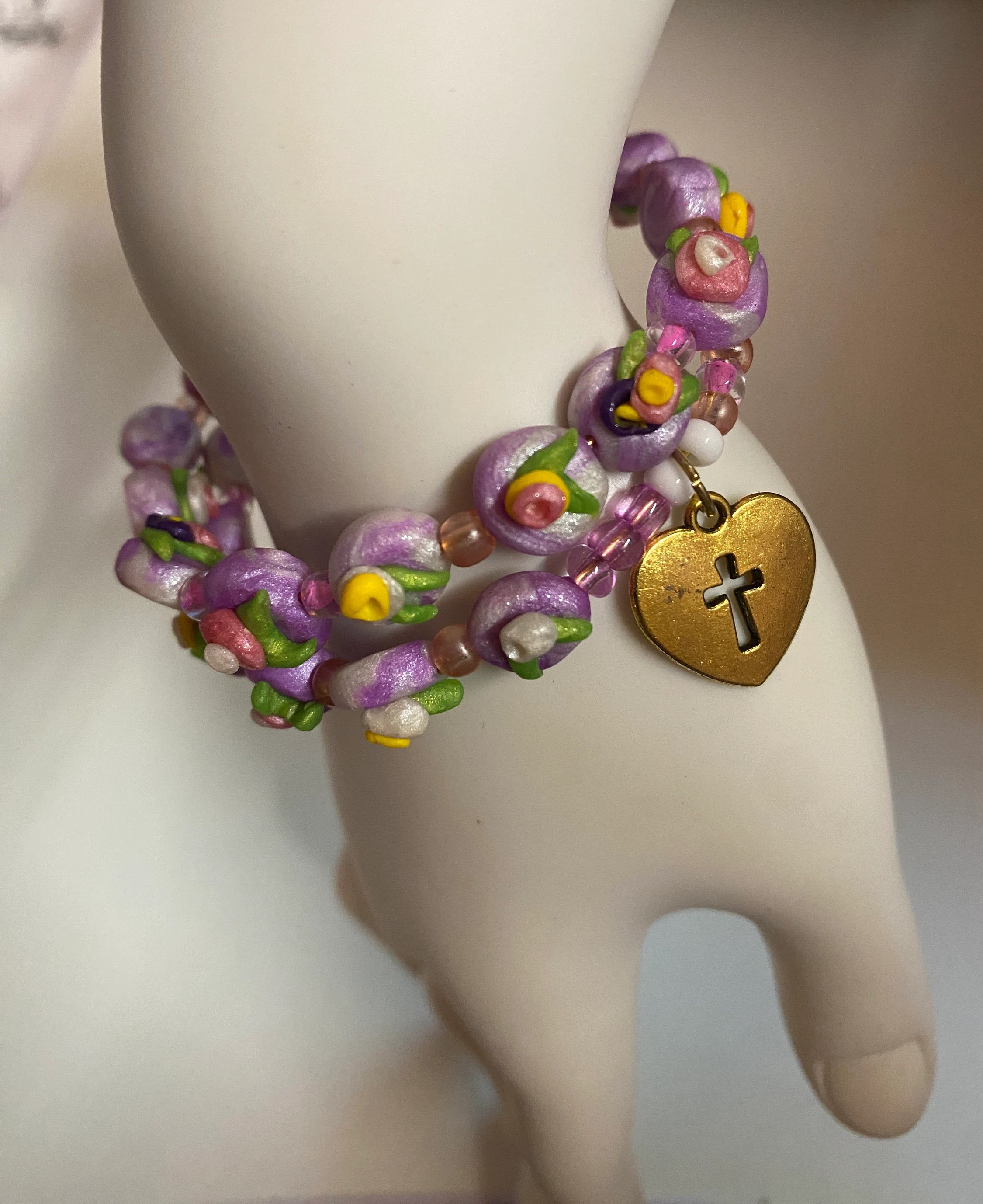 Expandable coil bracelet featuring hand crafted beads and a Christian cross heart charm, unique Christian gift, includes matching earrings