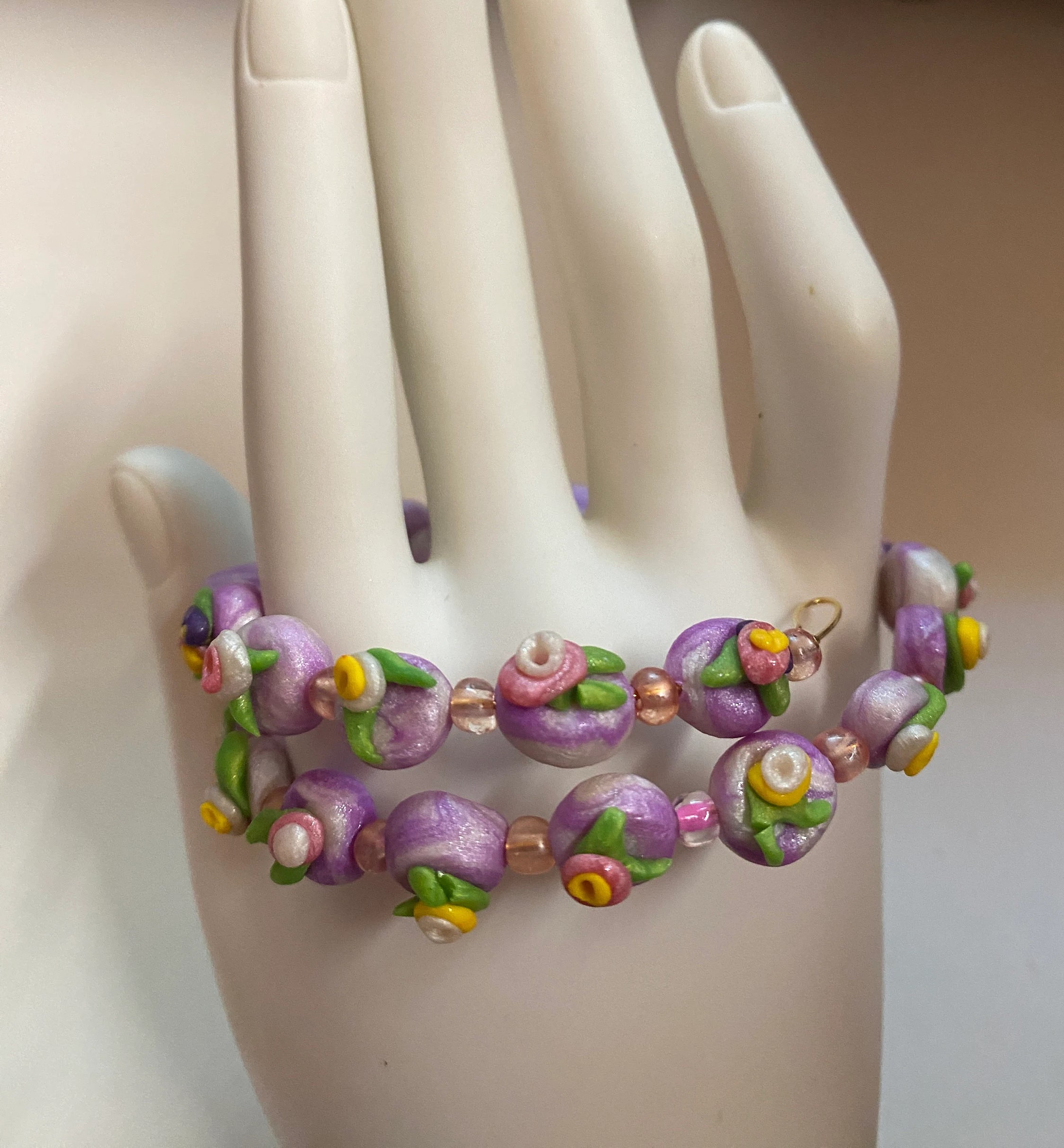 Expandable coil bracelet featuring hand crafted beads and a Christian cross heart charm, unique Christian gift, includes matching earrings