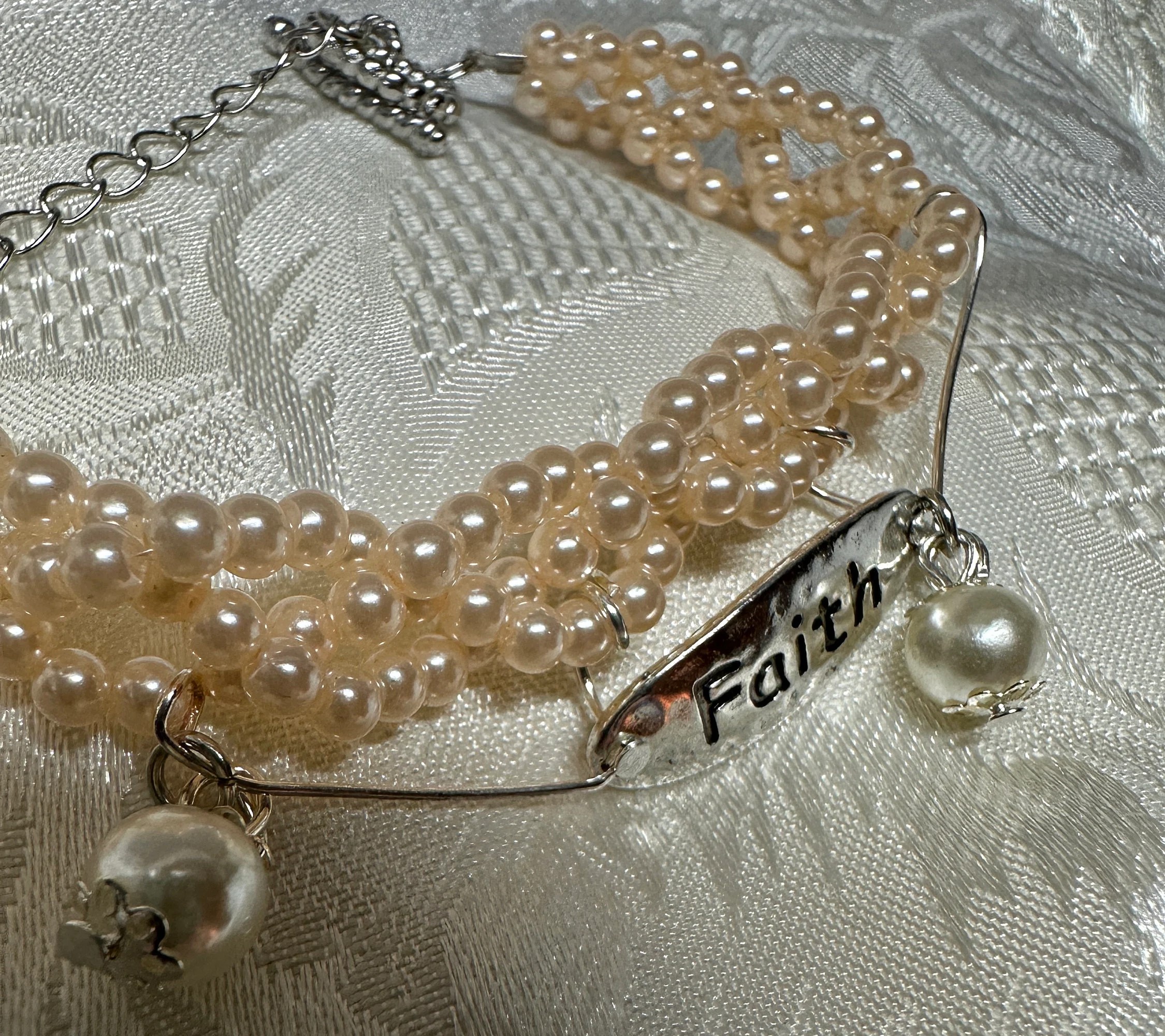 Christian bracelet with Faith charm, faux pearls, pinky peach and white colors, bracelet is 8 inches around wrist, coordinating earrings