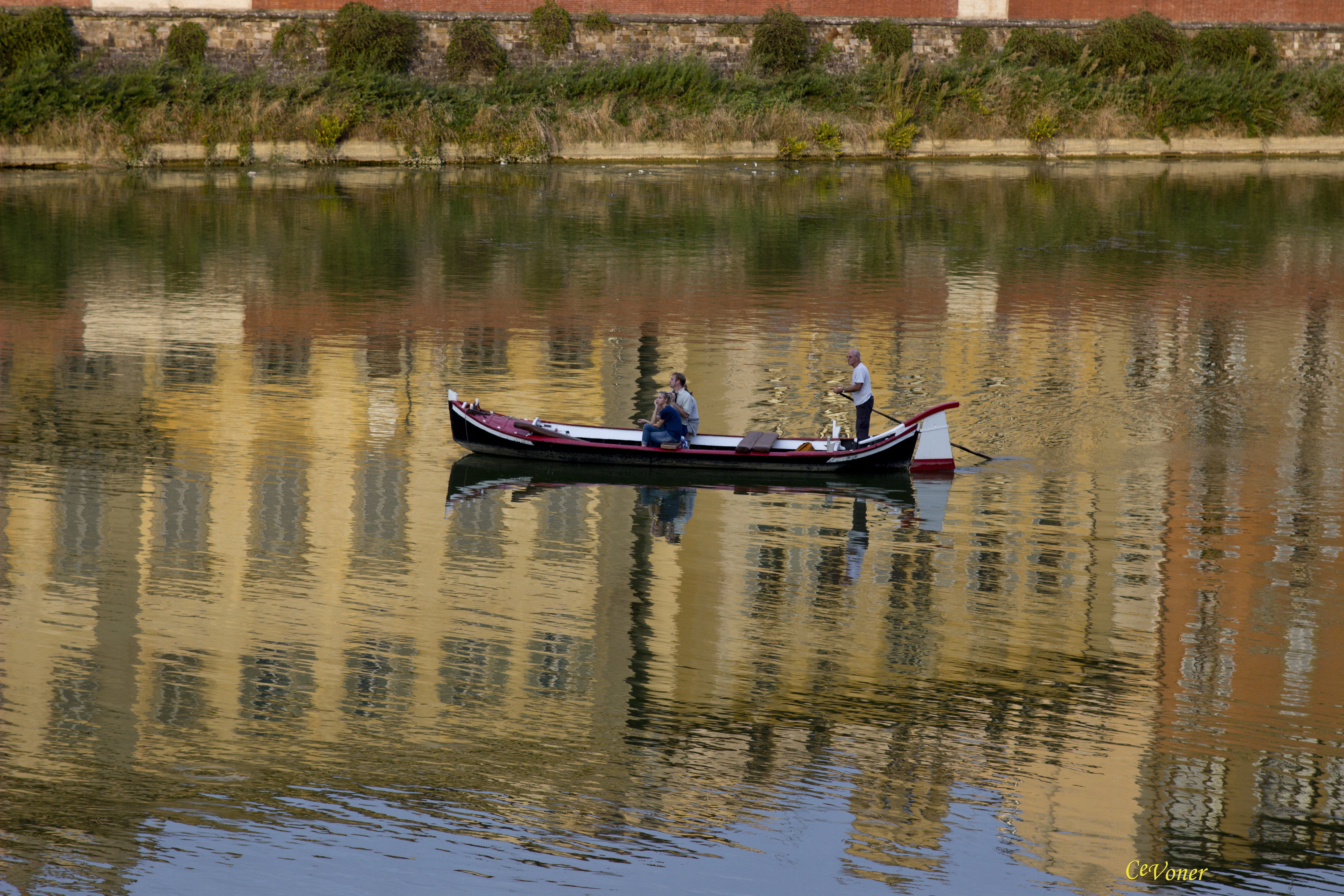 Fisherman on river in Florence, Italy