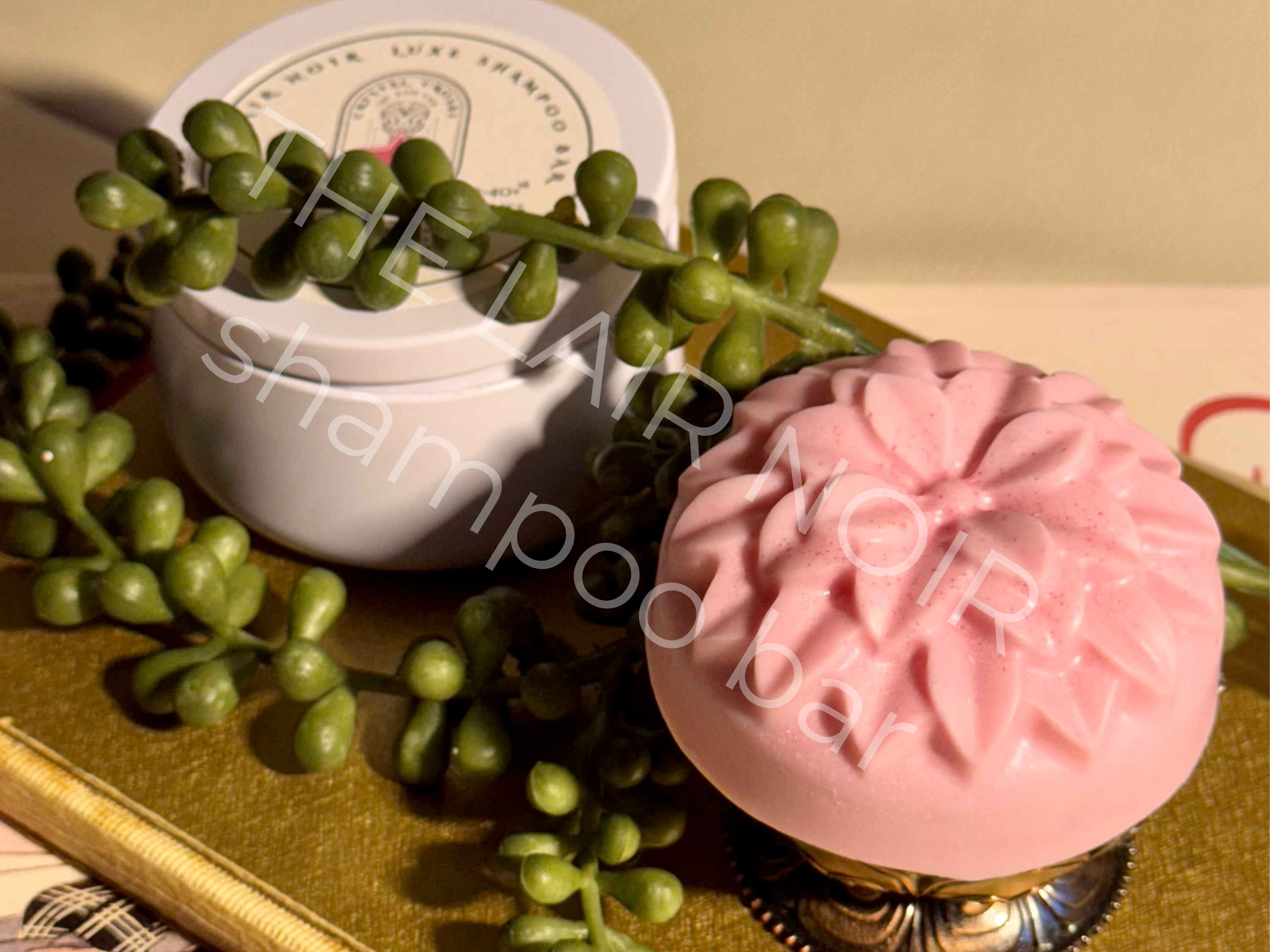 The OG (light pink) The Lair Noir Shampoo Bar created to address the appearance of thinning and overstressed tresses.