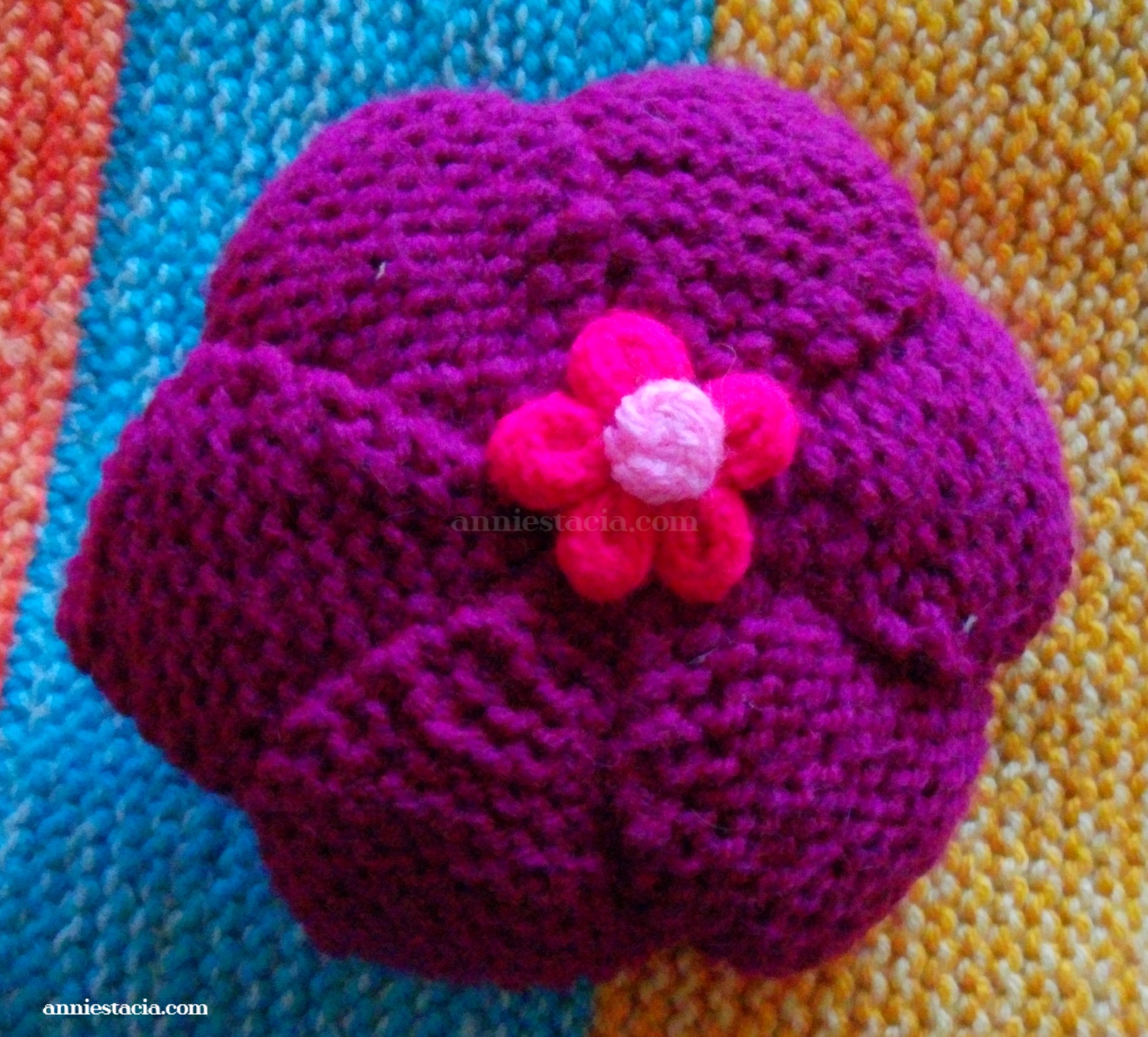 Dark pink knitted flower
