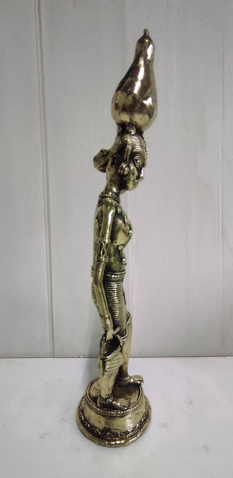 Brass Tribal Woman in Traditional Attire Holding a Tumba