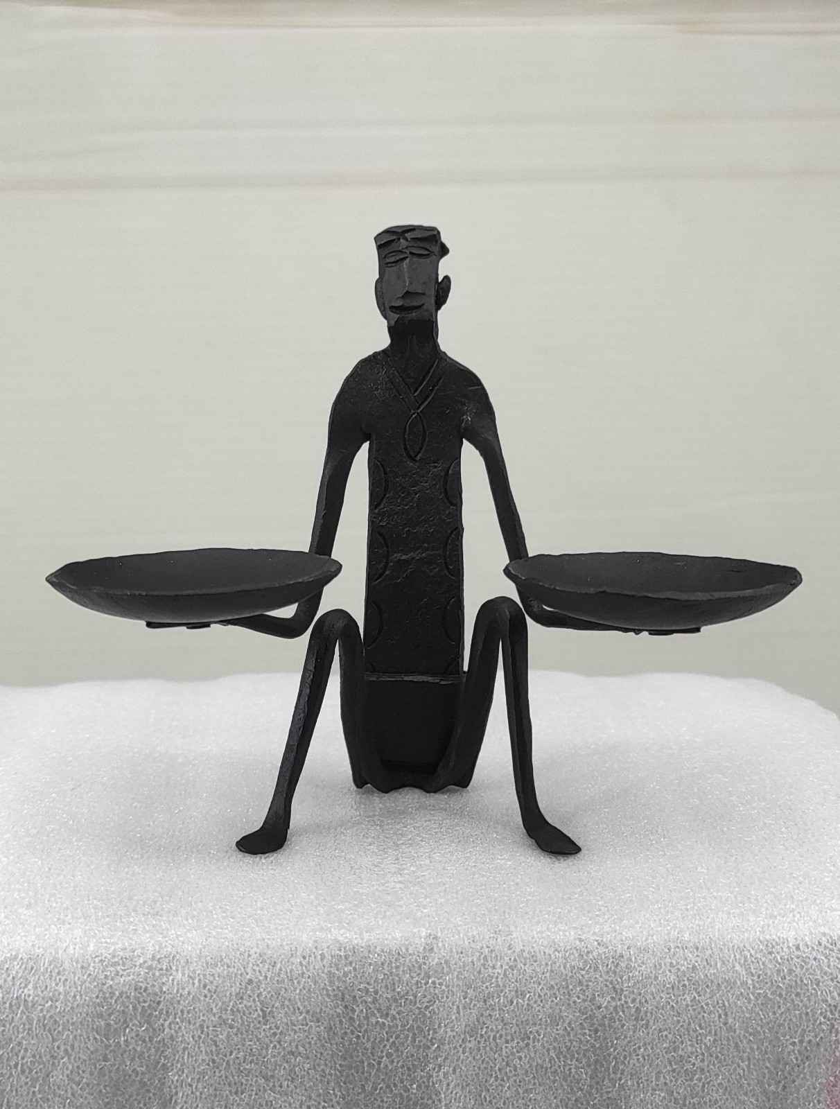 Iron Seated Man Holding Oil Lamps - Handcrafted Tribal Sculpture