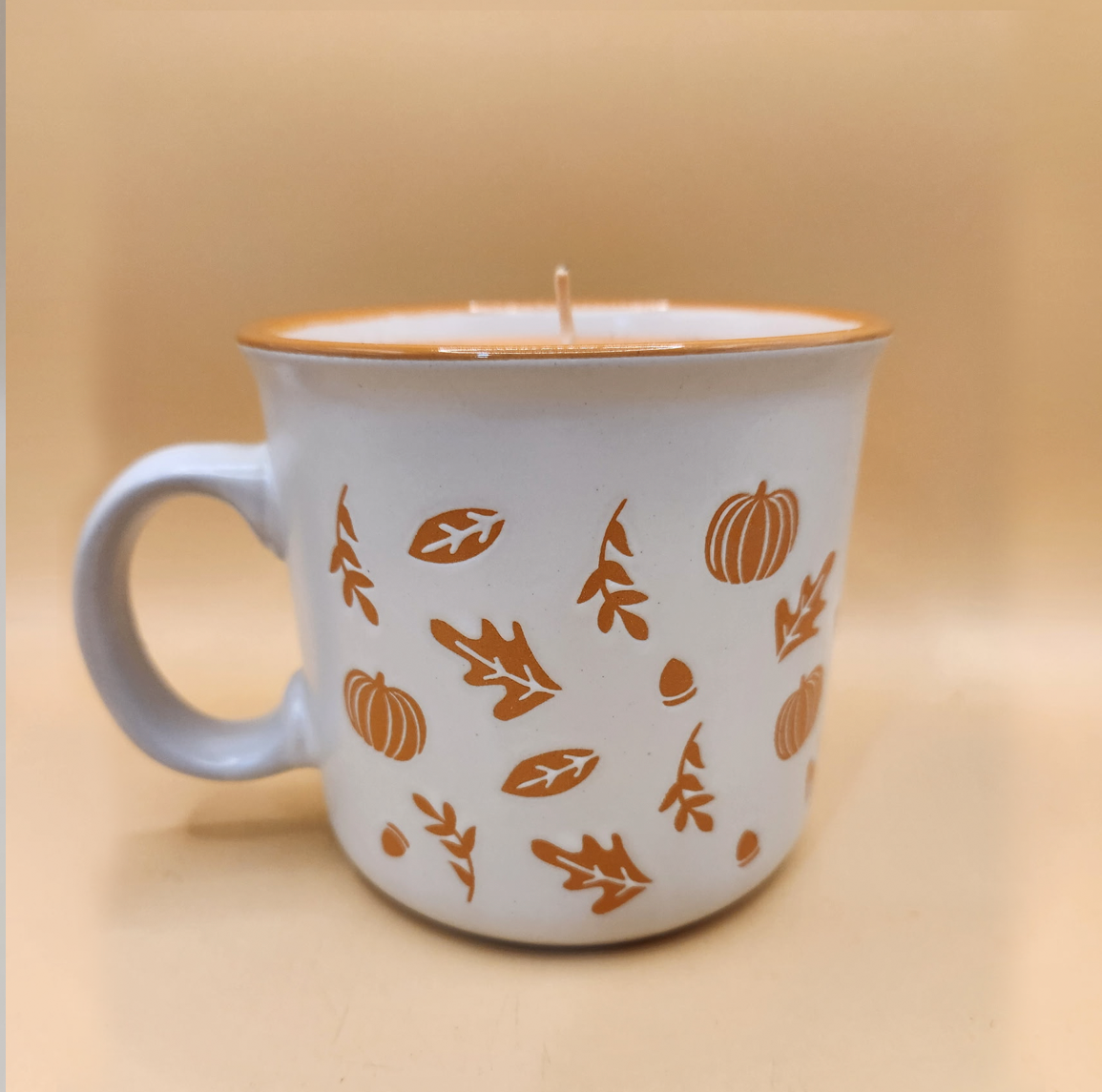 Autumn-themed ceramic mug candle
