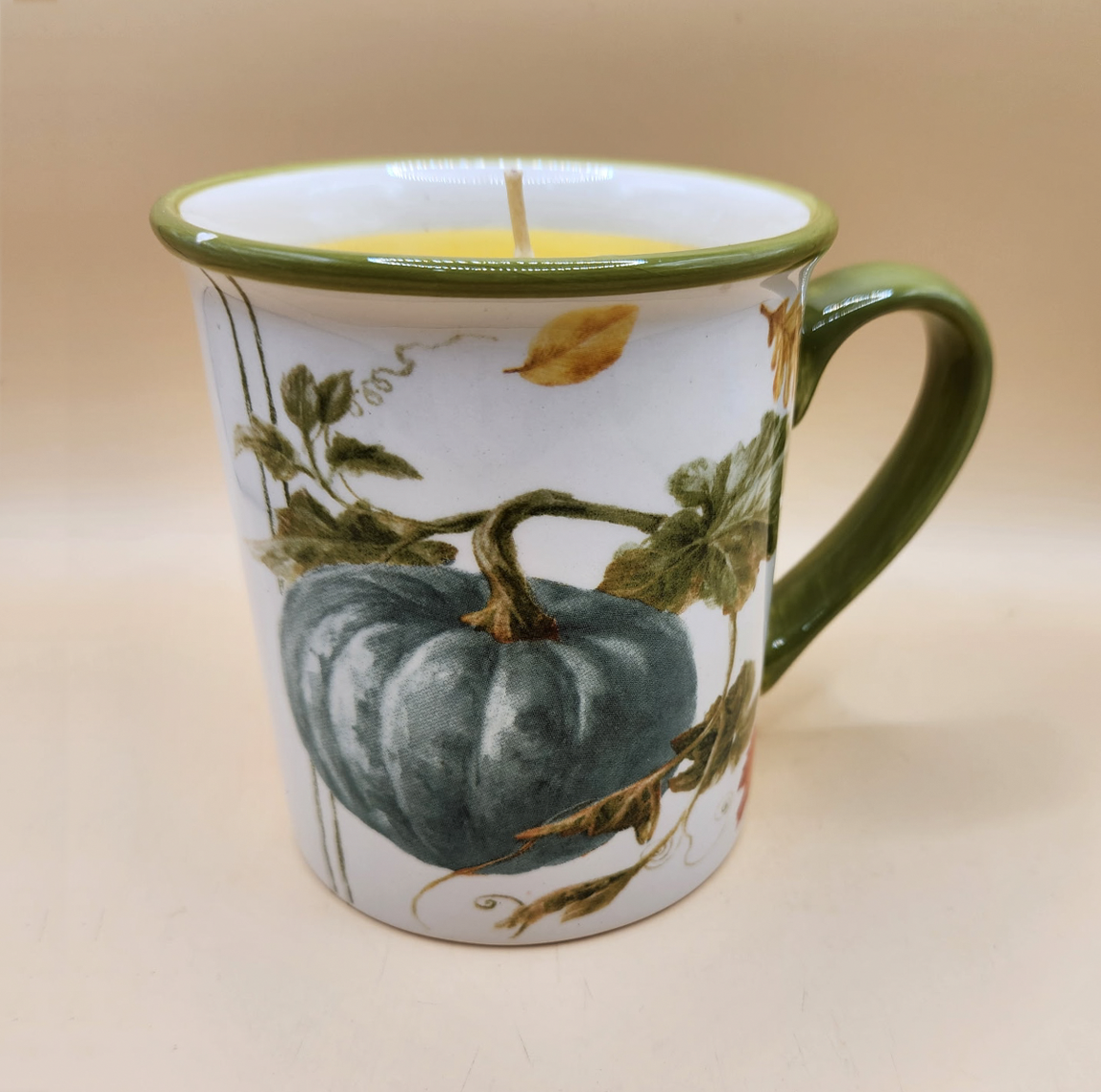 Pumpkin-themed ceramic mug candle