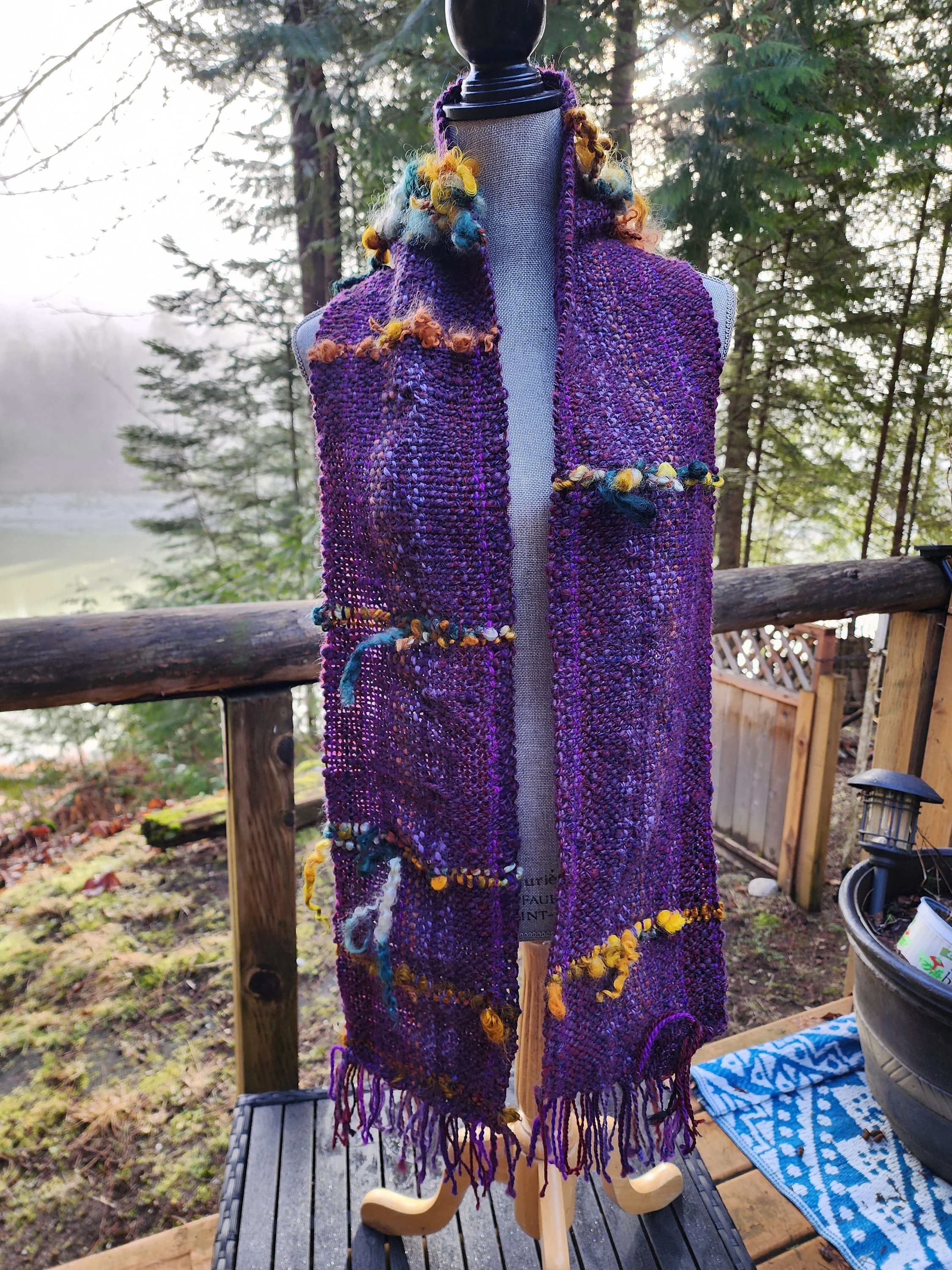 Handspun, hand dyed and woven purple wool with colorful art yarn added.  Unique art scarf.yarn