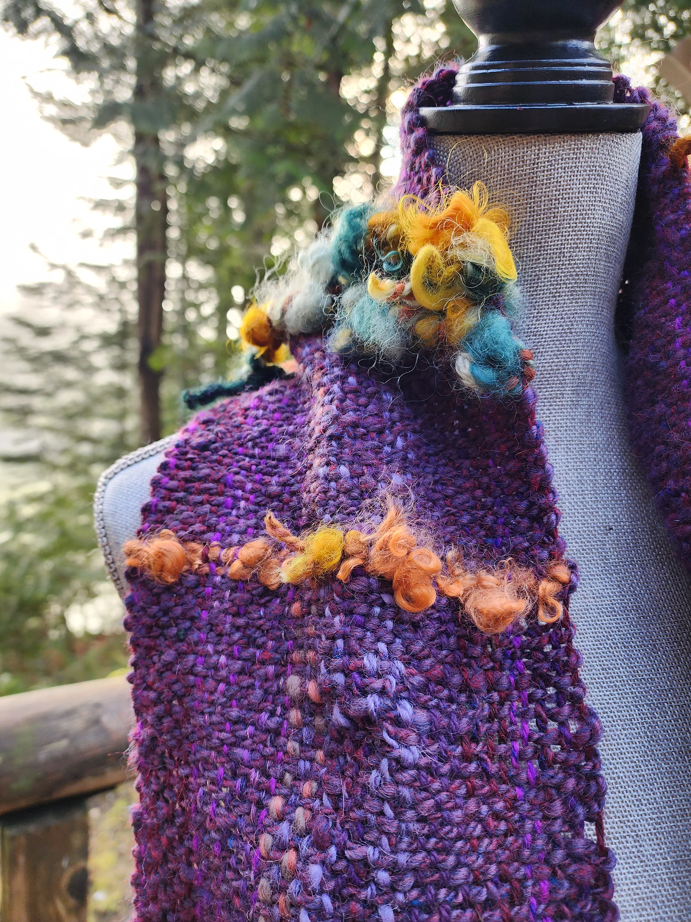 Handspun, hand dyed and woven purple wool with colorful art yarn added.  Unique art scarf.yarn