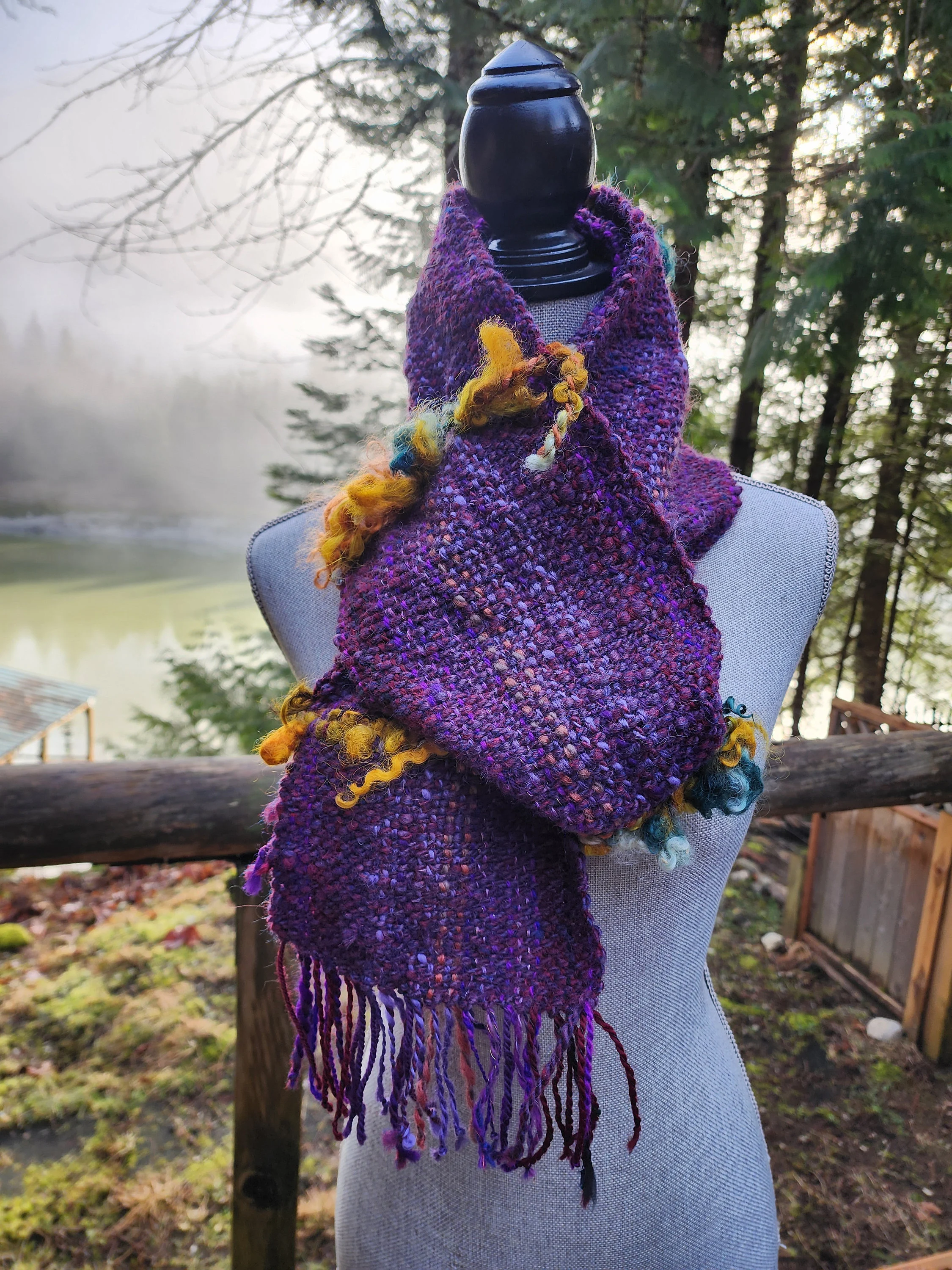 Handspun, hand dyed and woven purple wool with colorful art yarn added.  Unique art scarf.yarn