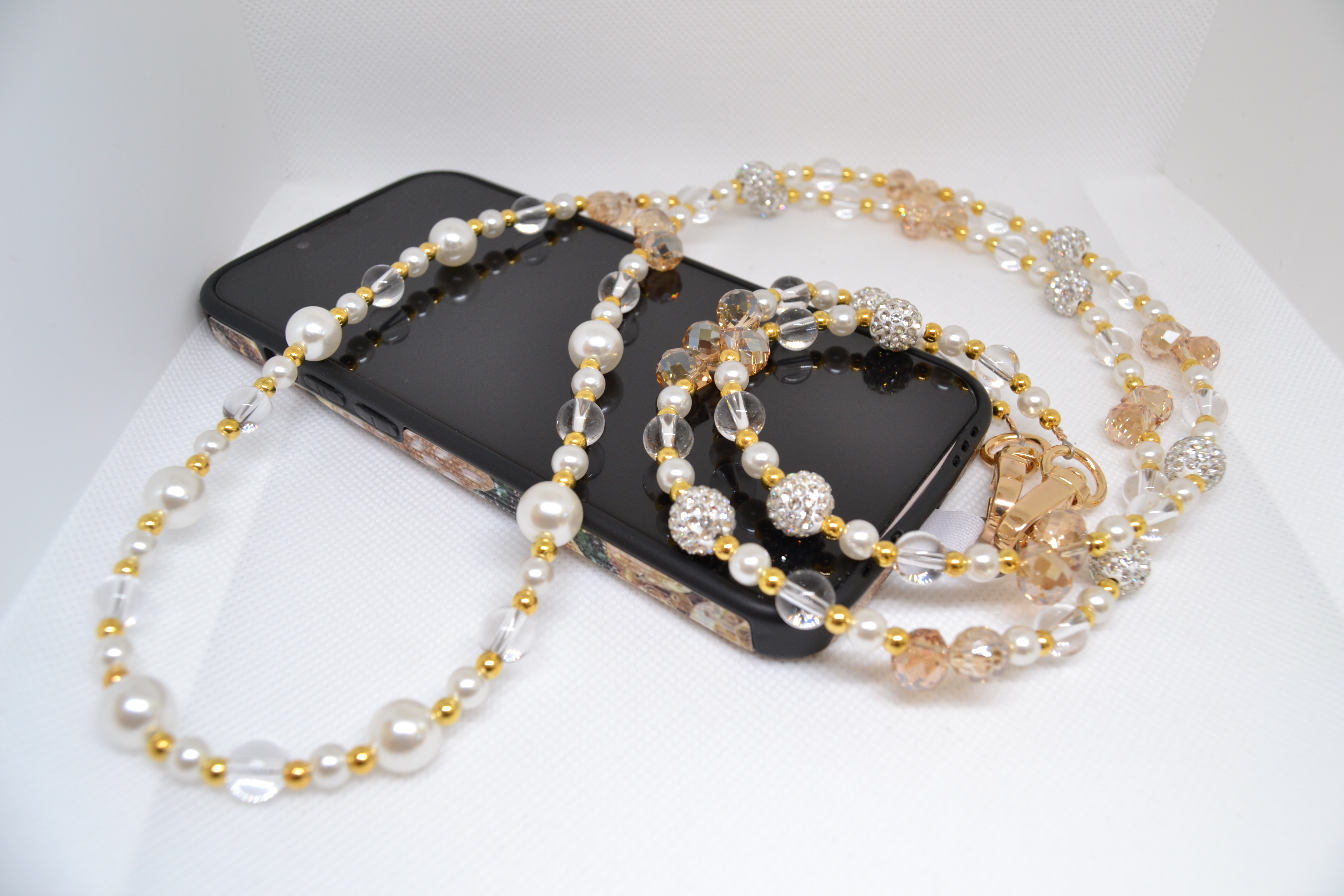 Žėrintys karoliai telefonui