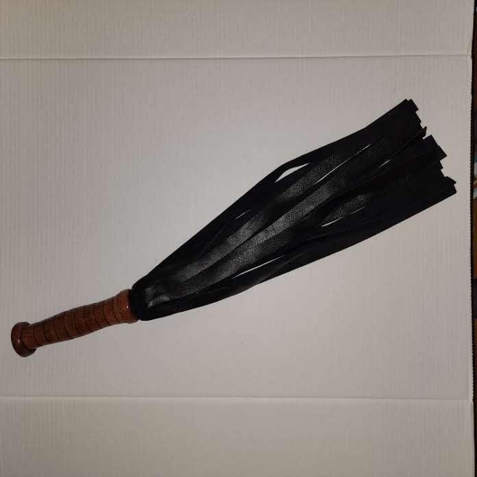 Black motochap leather with a rosewood handle flogger