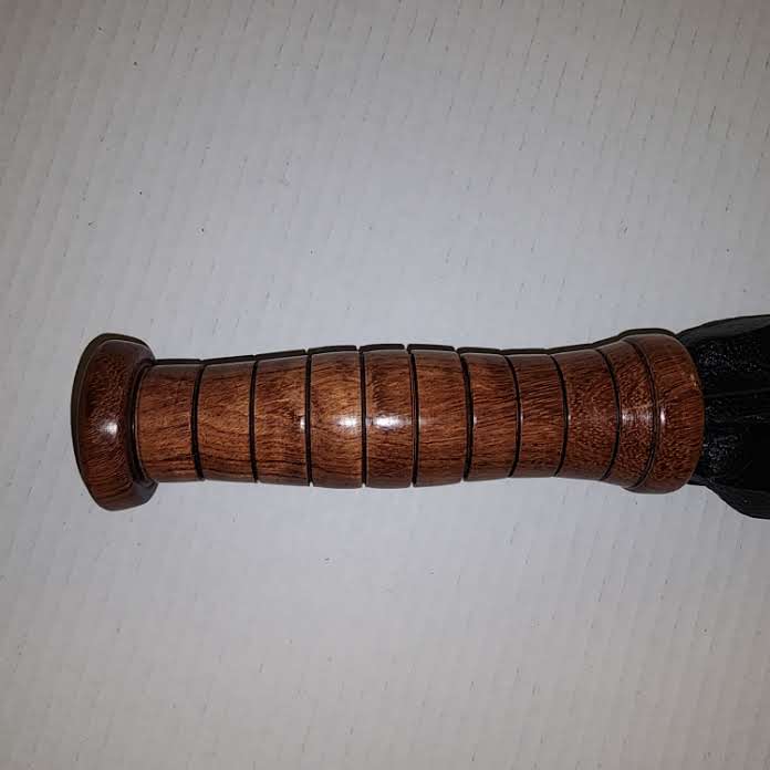 Black motochap leather with a rosewood handle flogger