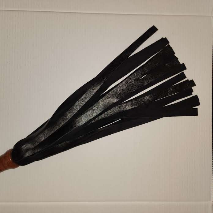 Black motochap leather with a rosewood handle flogger
