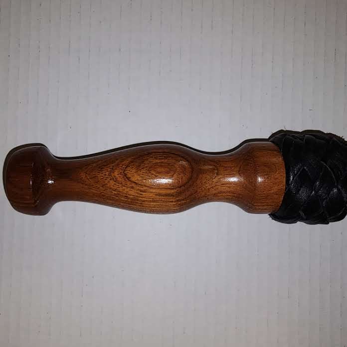 Black bullhide leather with a rosewood handle flogger