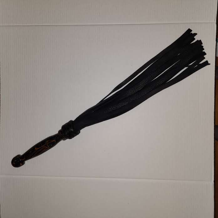 Orange and black acrylic handled flogger with black bullhide falls