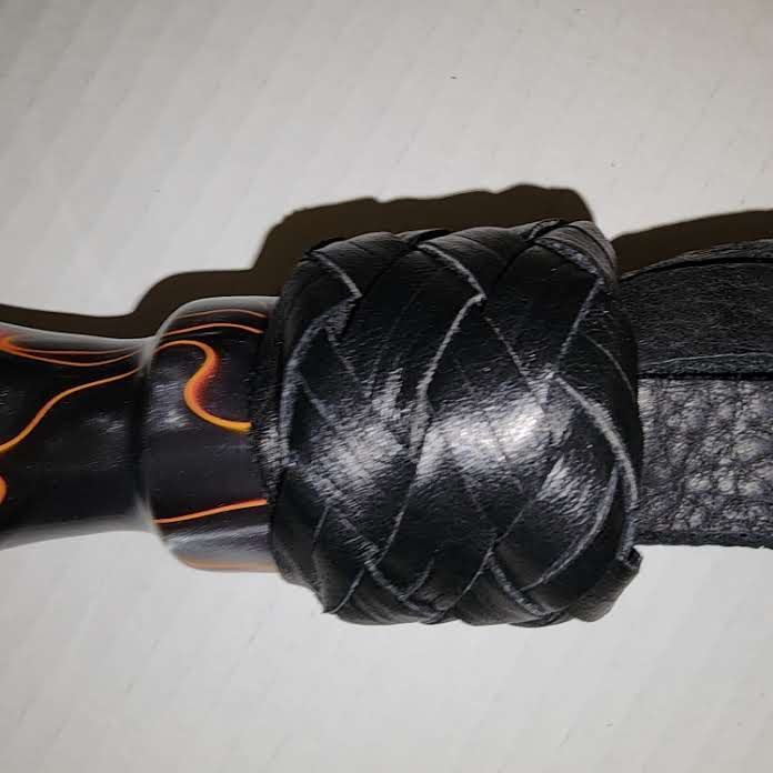 Orange and black acrylic handled flogger with black bullhide falls