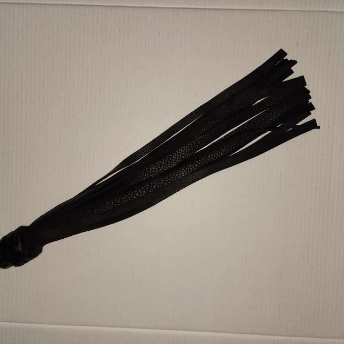 Orange and black acrylic handled flogger with black bullhide falls