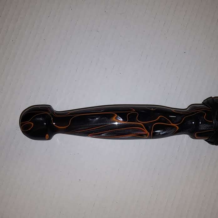 Orange and black acrylic handled flogger with black bullhide falls