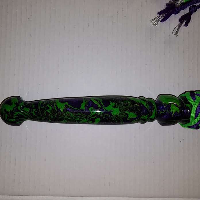 Purple and green acrylic handled flogger with purple and green paracord falls