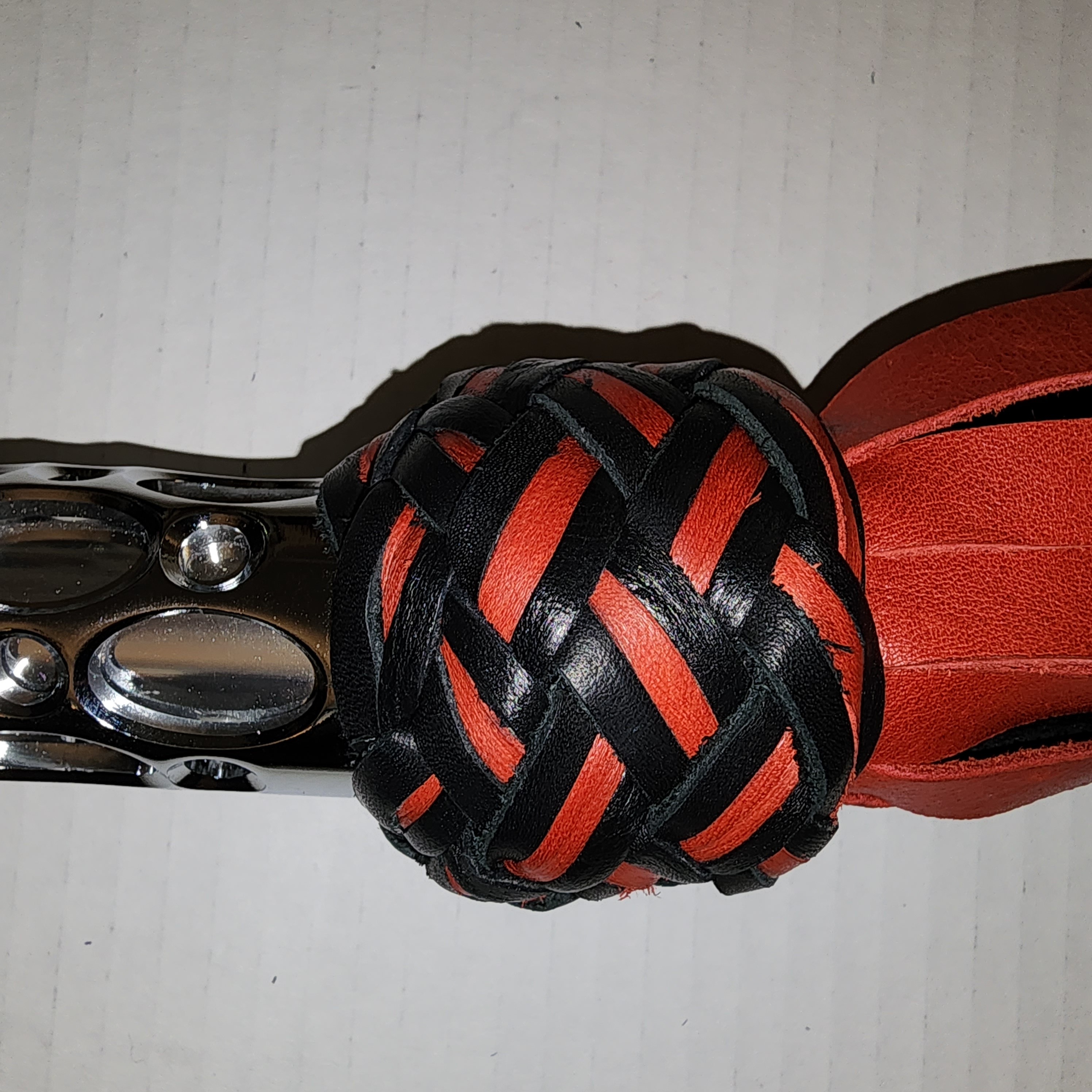 Aluminum motorcycle grip handled flogger with black bullhide leather and red motochap leather falls