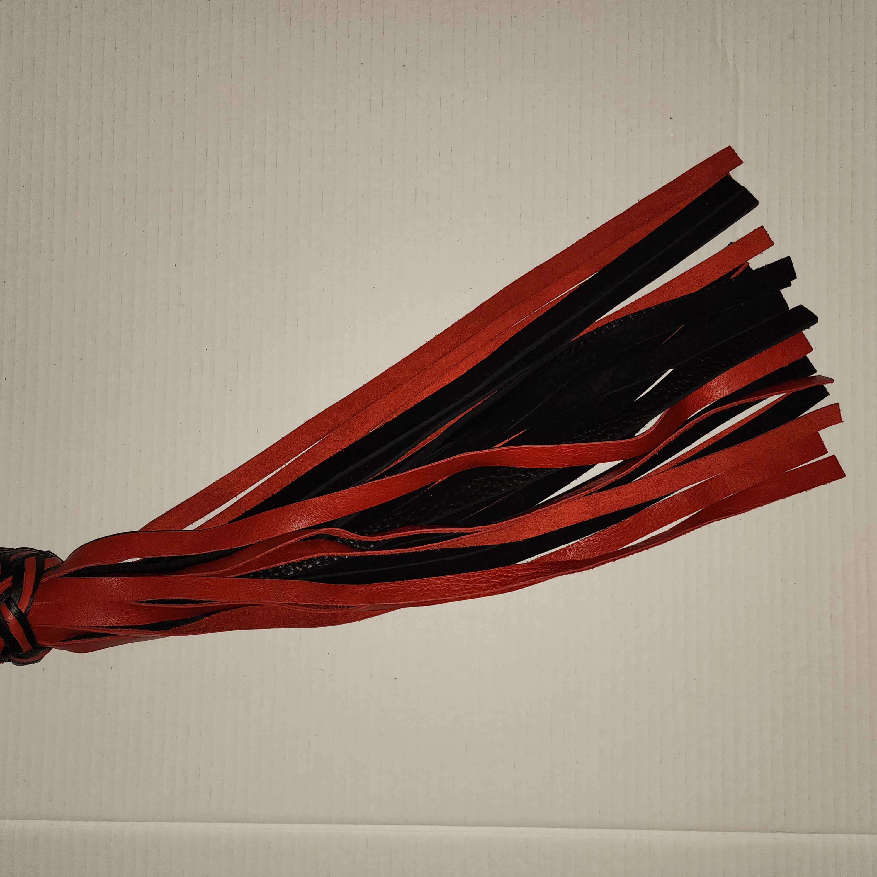 Aluminum motorcycle grip handled flogger with black bullhide leather and red motochap leather falls