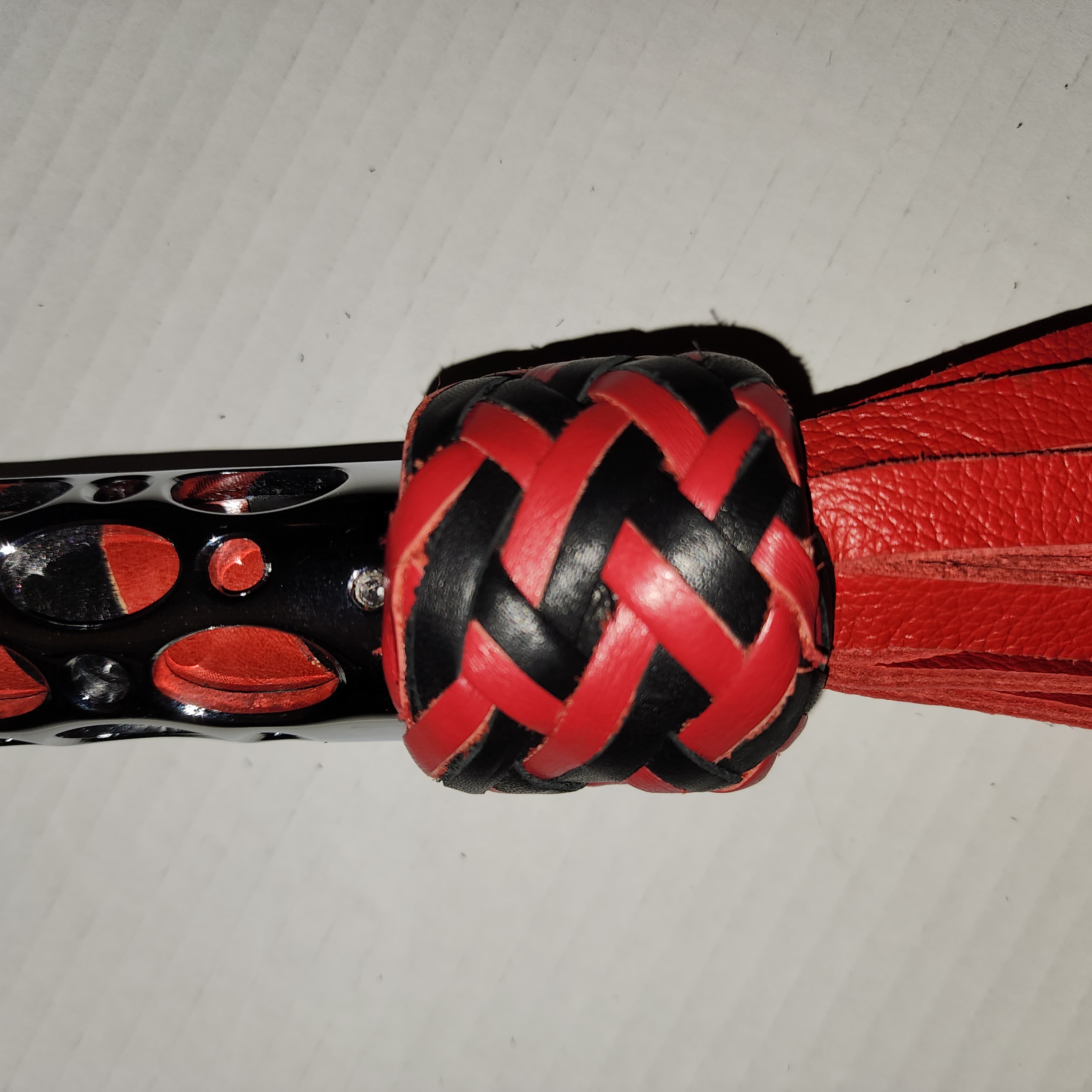 Aluminum motorcycle grip handled flogger braided with red and black leather and red motochap leather falls