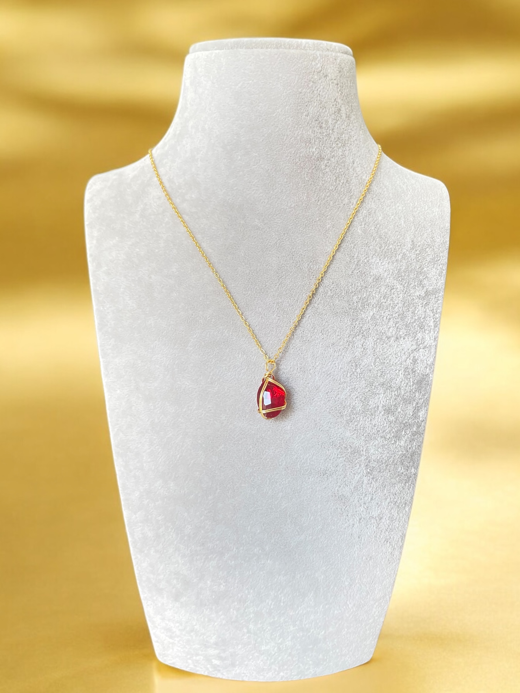 Gold Necklace with Red Gem Pendant