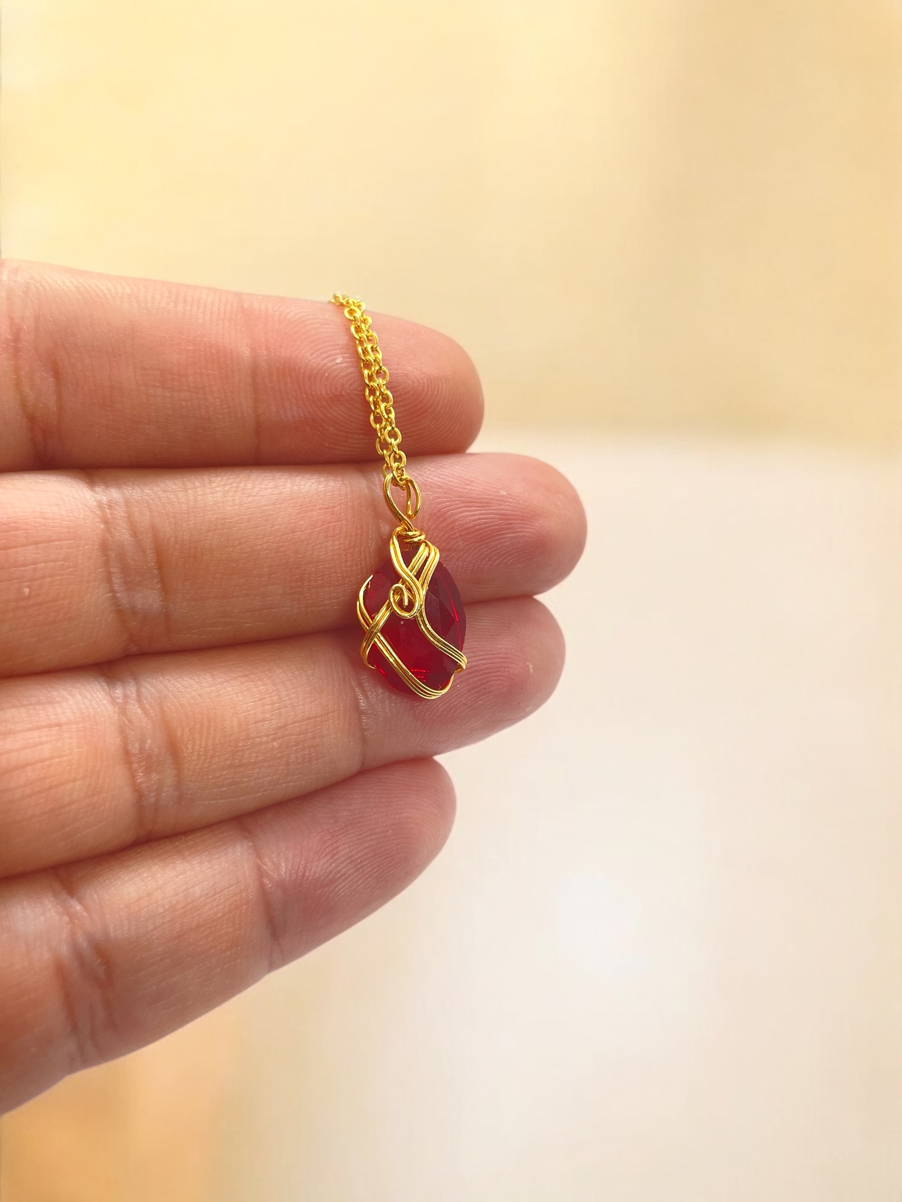 Gold Necklace with Red Gem Pendant