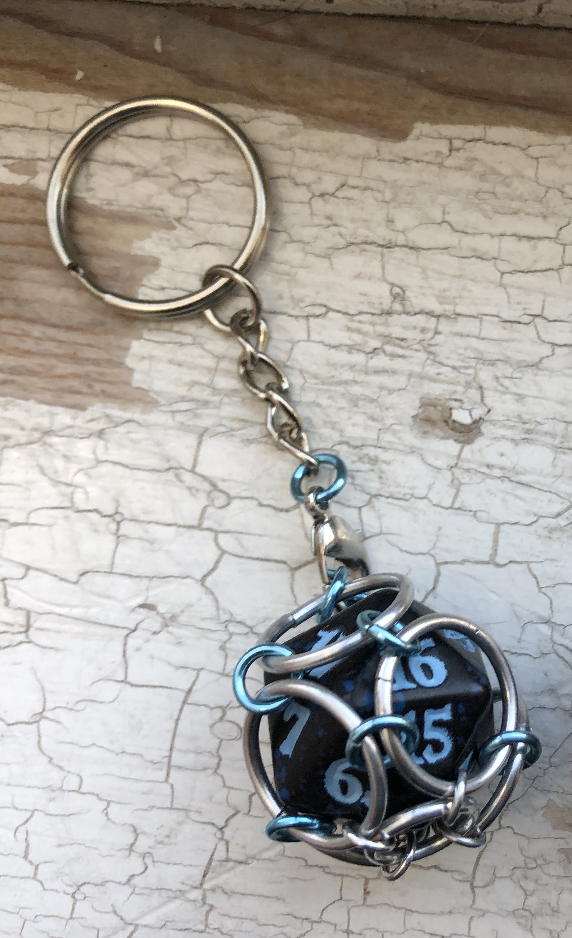 Playable Caged Spindown d20 Keychain, Blue