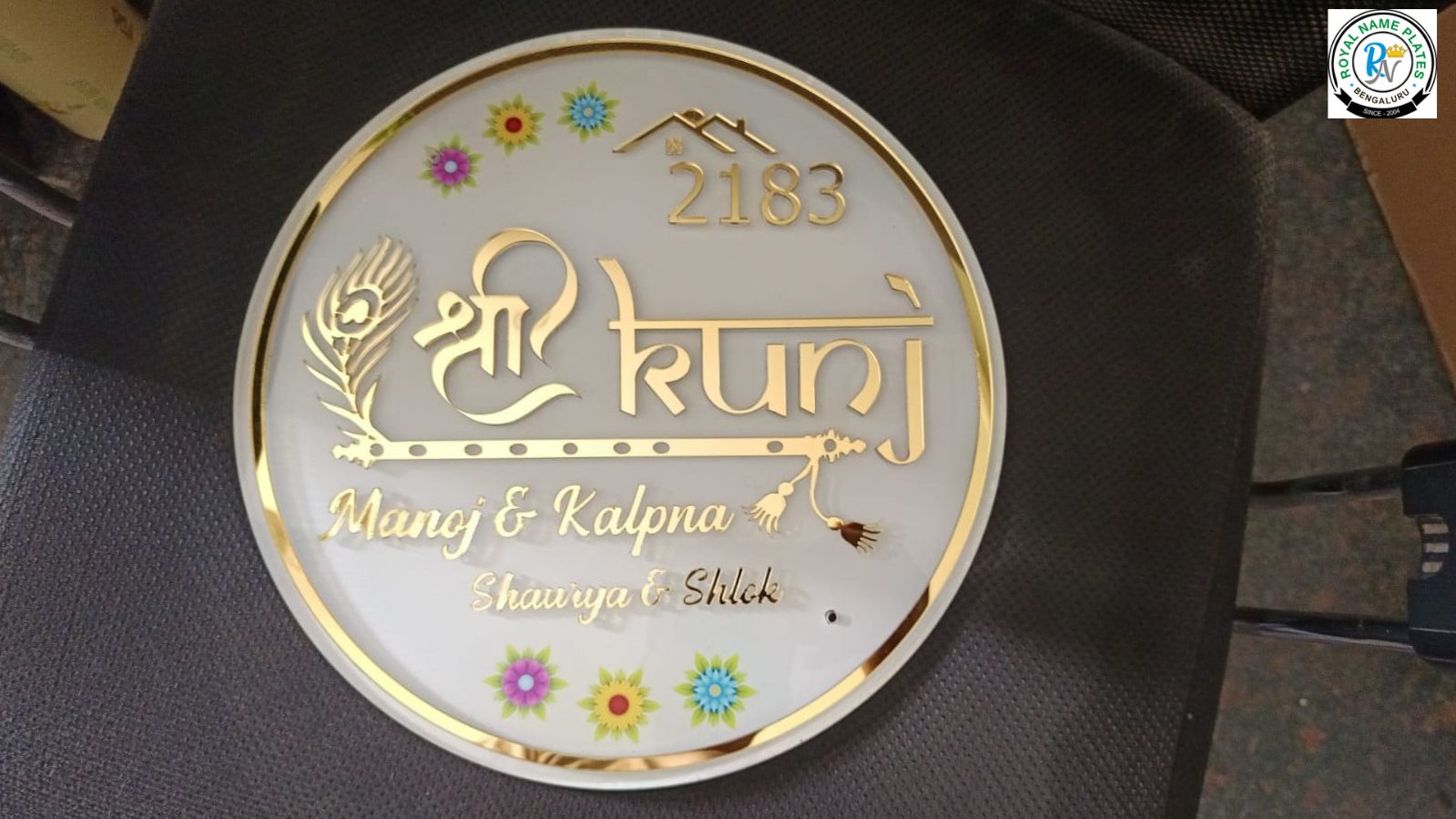 Circular Acrylic House Name Plate with Flute & Peacock Feather Design