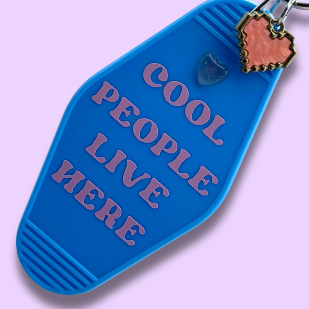 Cool People Live Here Blue Heart Motel Keychain