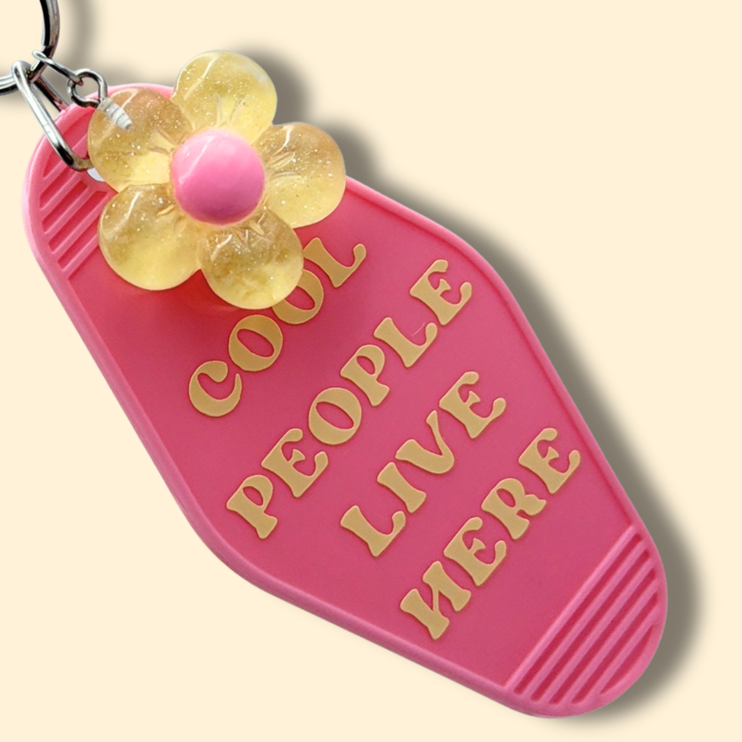 Cool People Live Here Pink Flower Motel Keychain