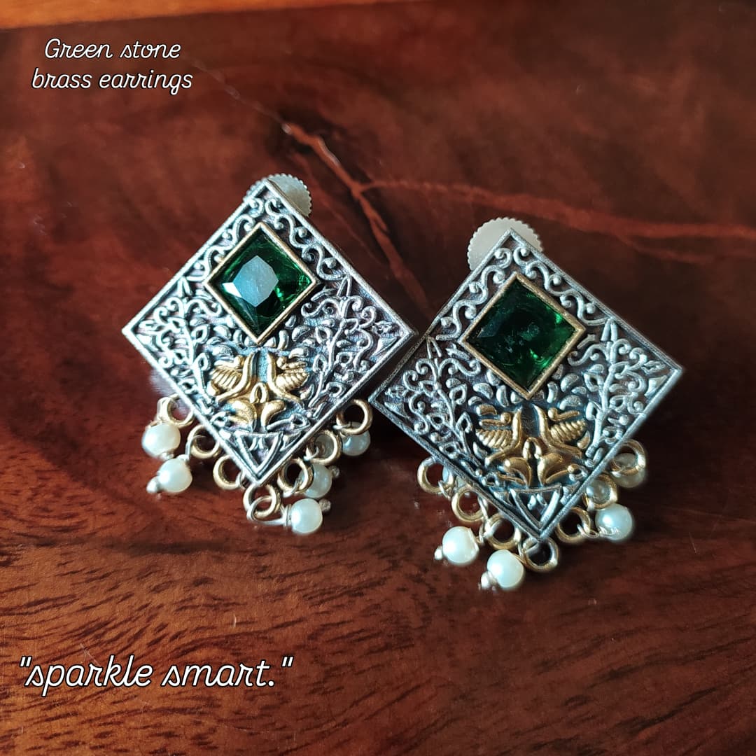 A Pair Of Earrings With Green Stones And Pearls