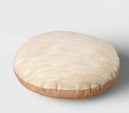 Round beige throw pillow