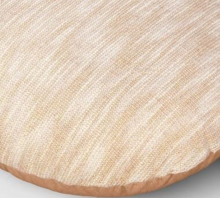 Round beige throw pillow