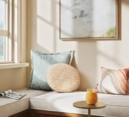 Round beige throw pillow