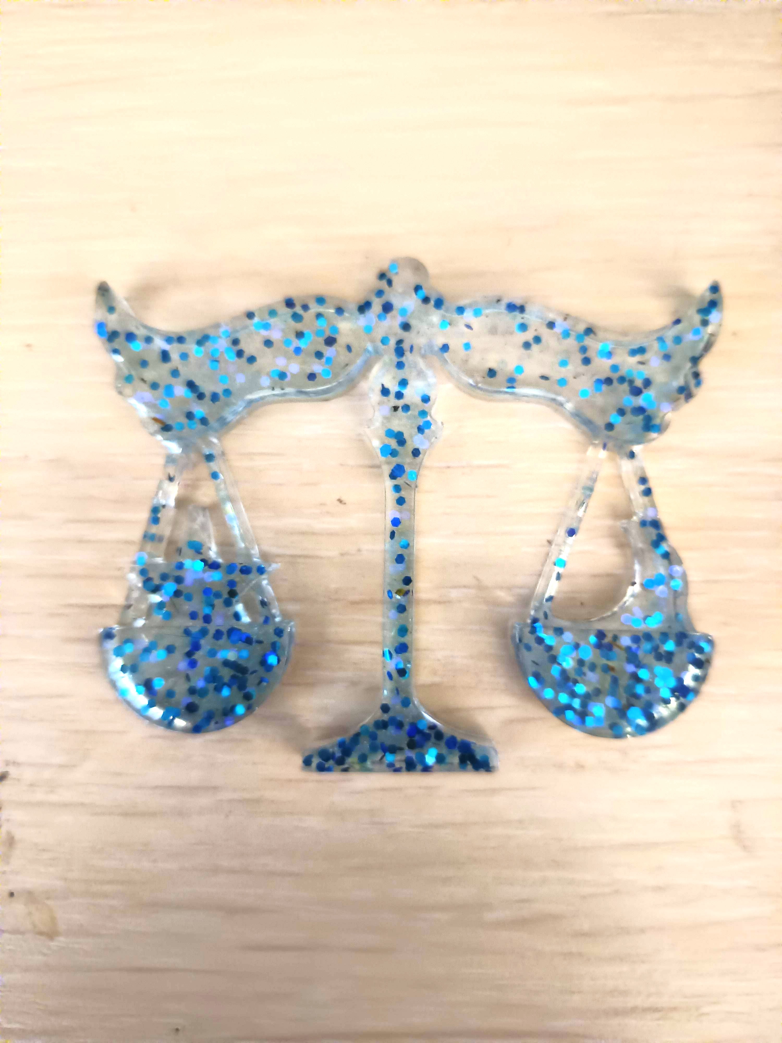 Signe astrologique de la Balance transparente et paillettes bleues