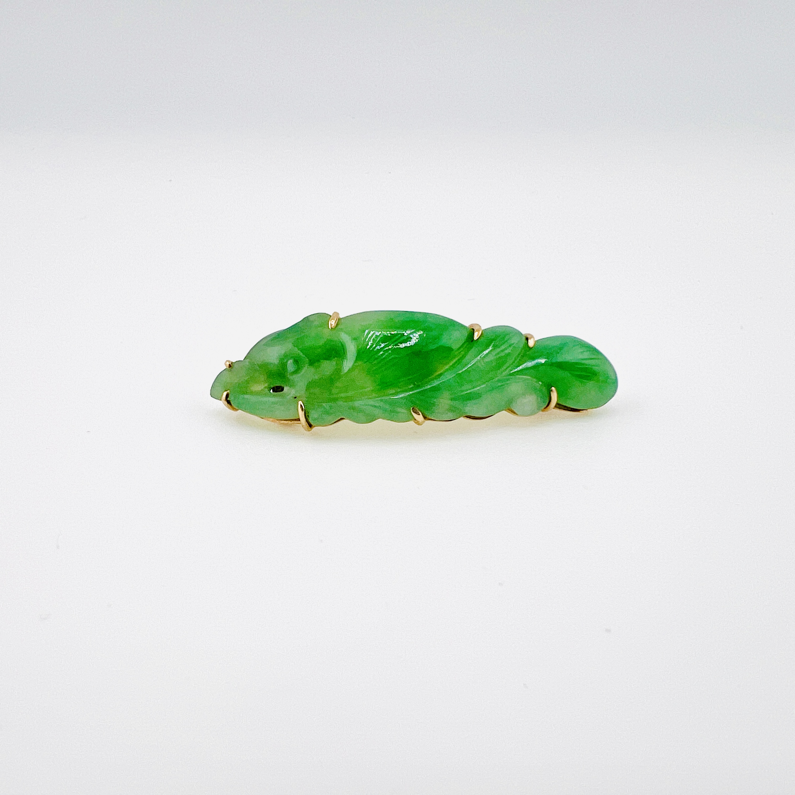 Antique green jadeite fish brooch in gold setting