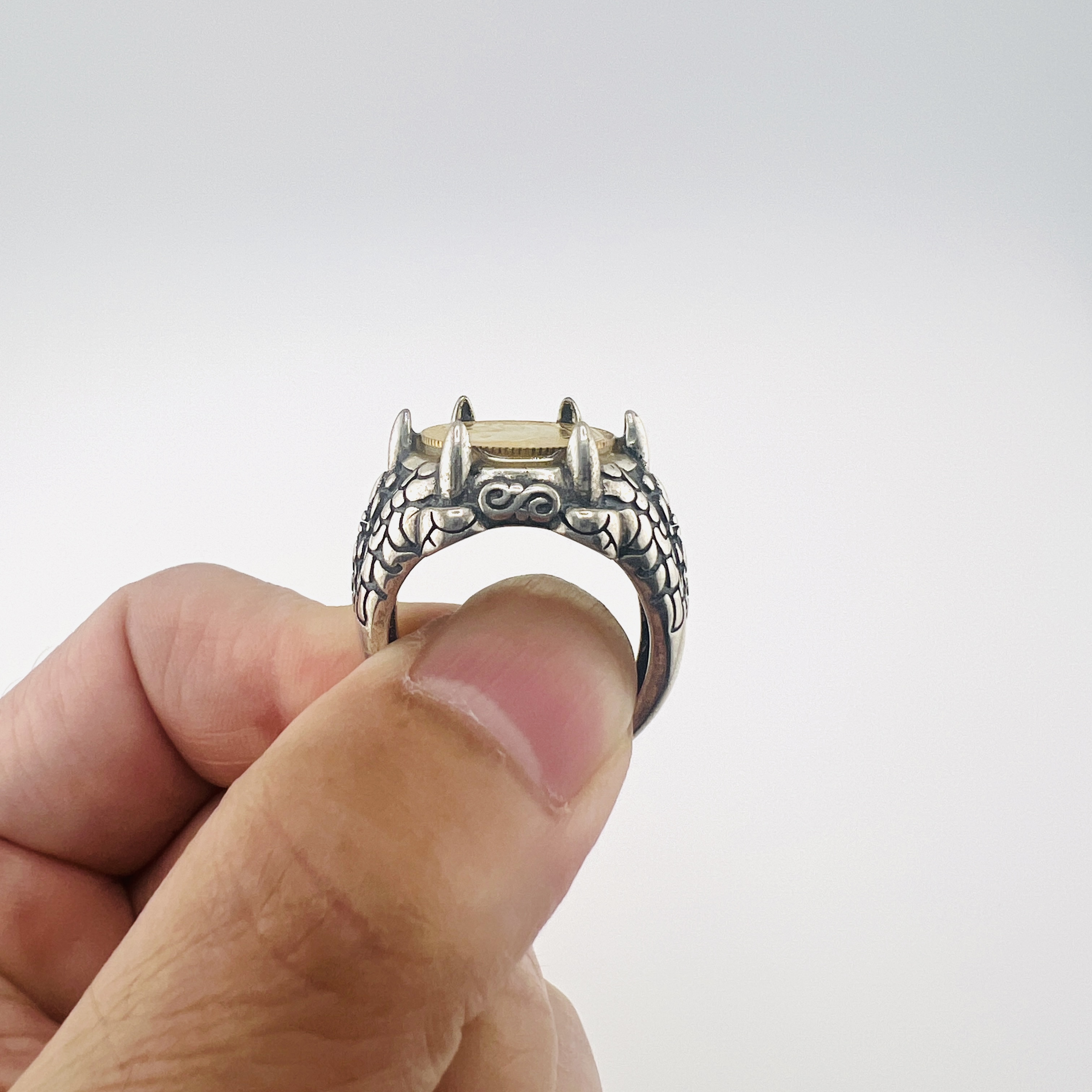Gold Panda coin in dragon claws ring
