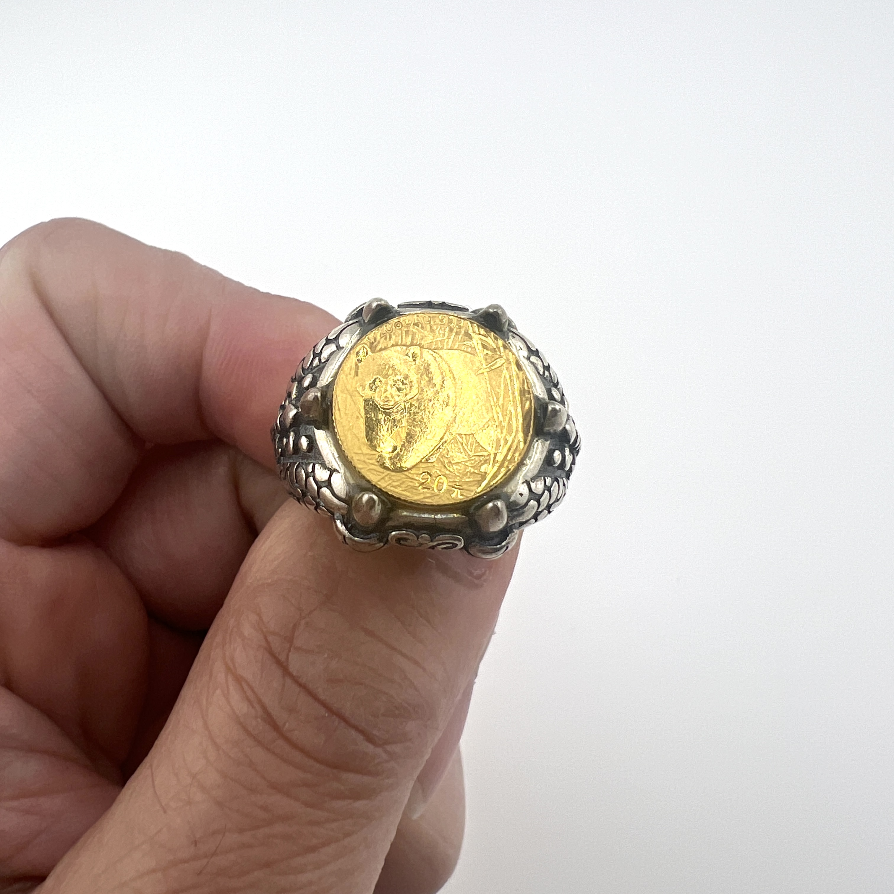 Gold Panda coin in dragon claws ring
