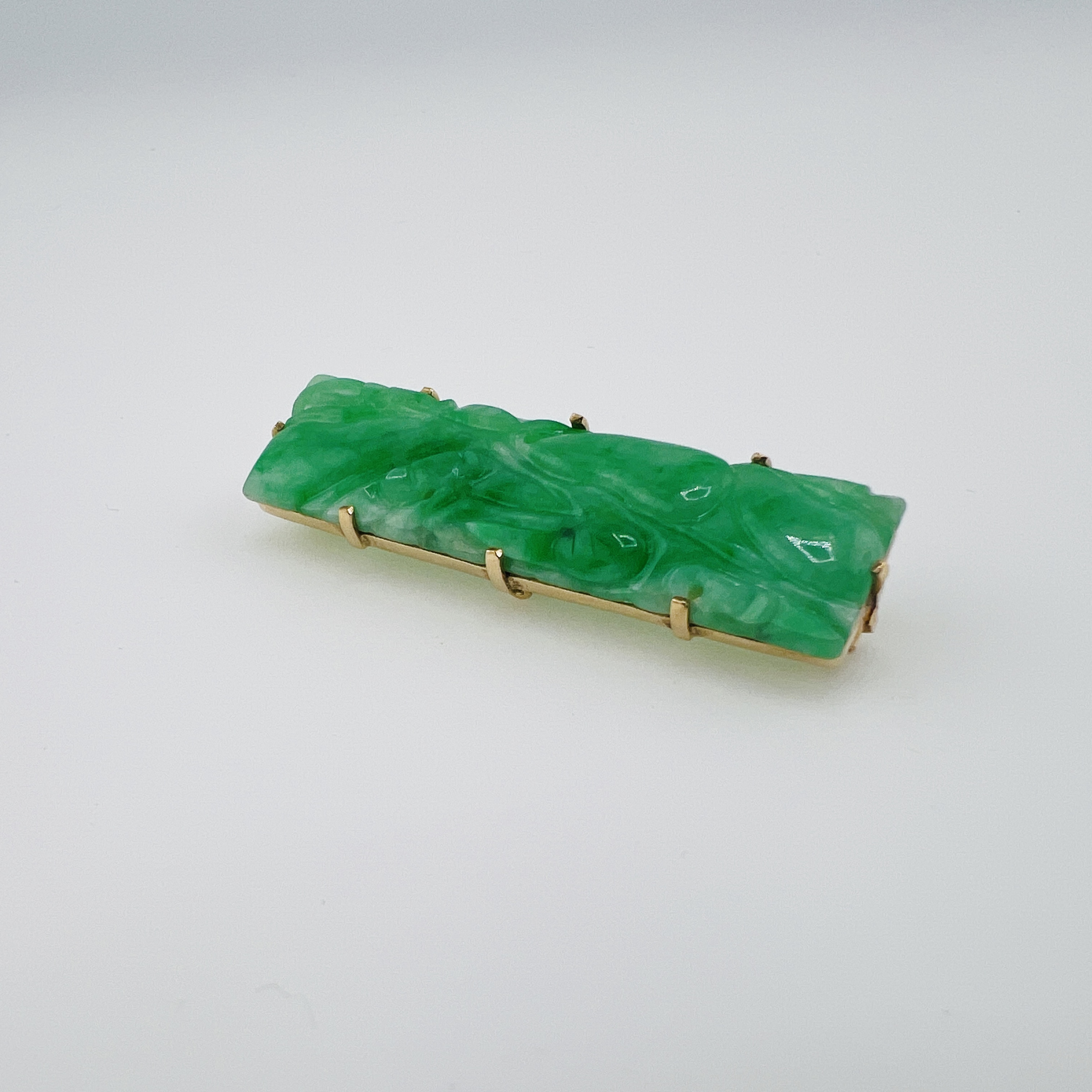 Green jadeite bar brooch in gold setting