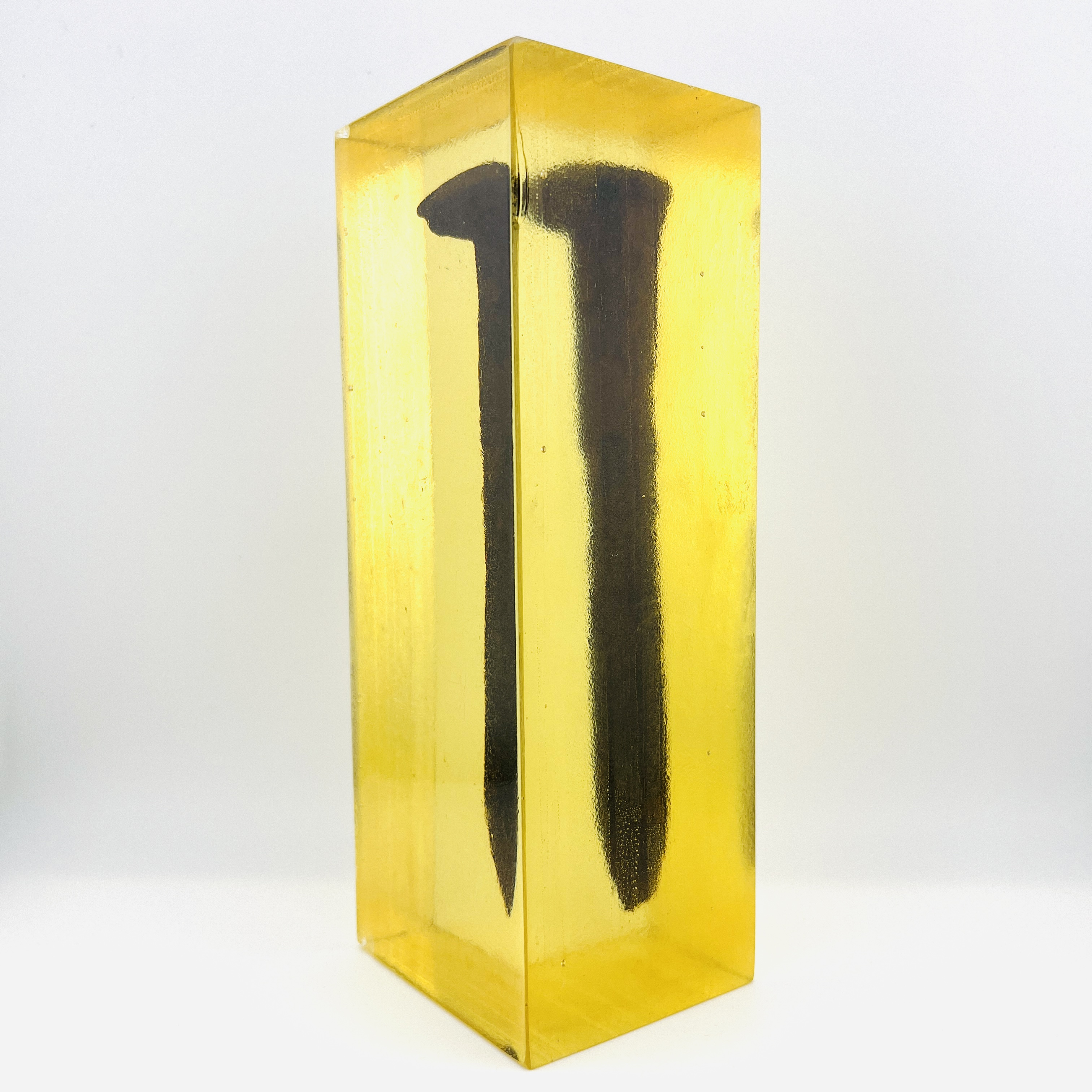 Original Pacific Coast railroad steel spike resin display block in amber color